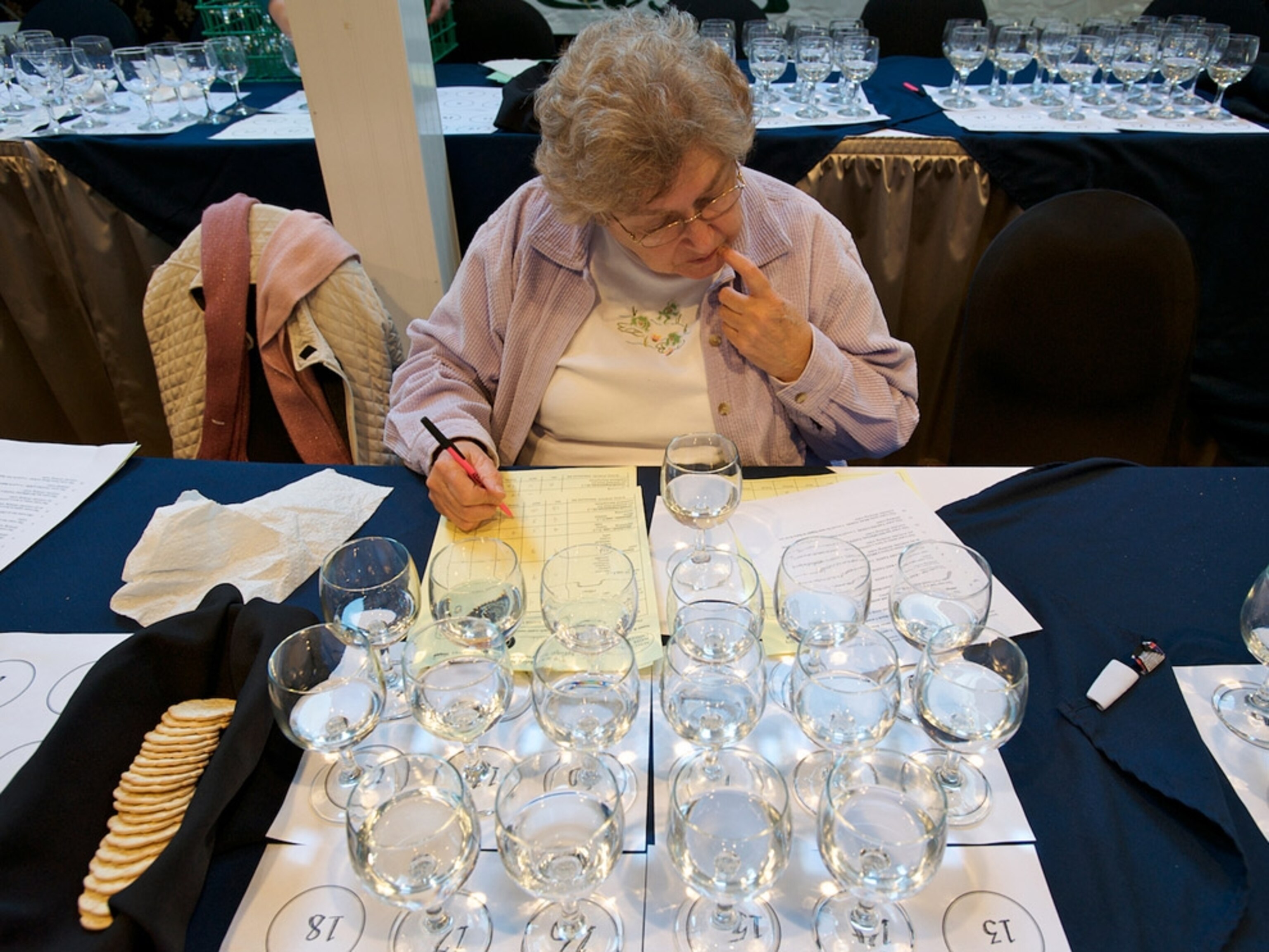 A woman at a table with glasses of water