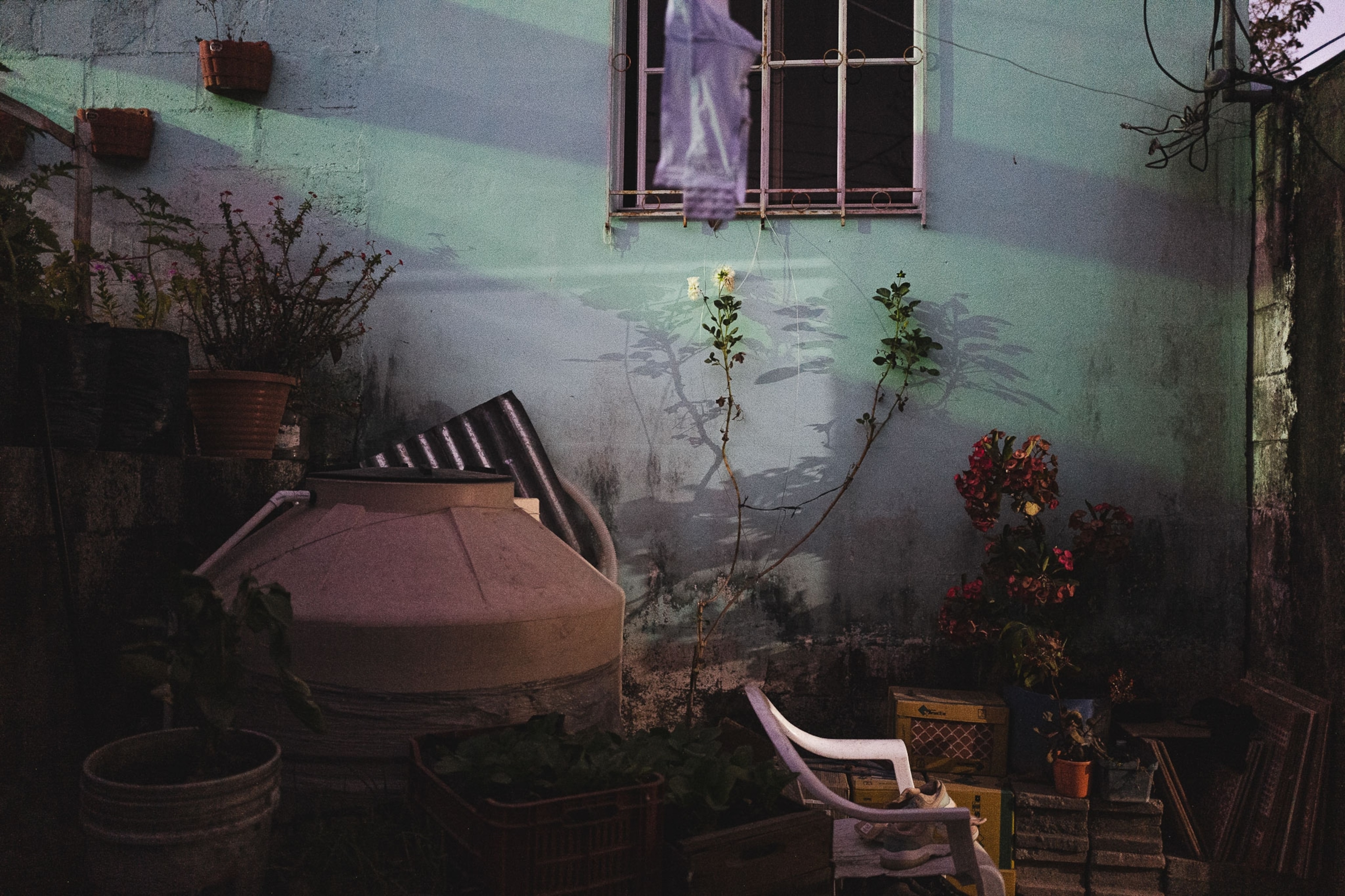 a water tank outside of a woman's house in El Salvador