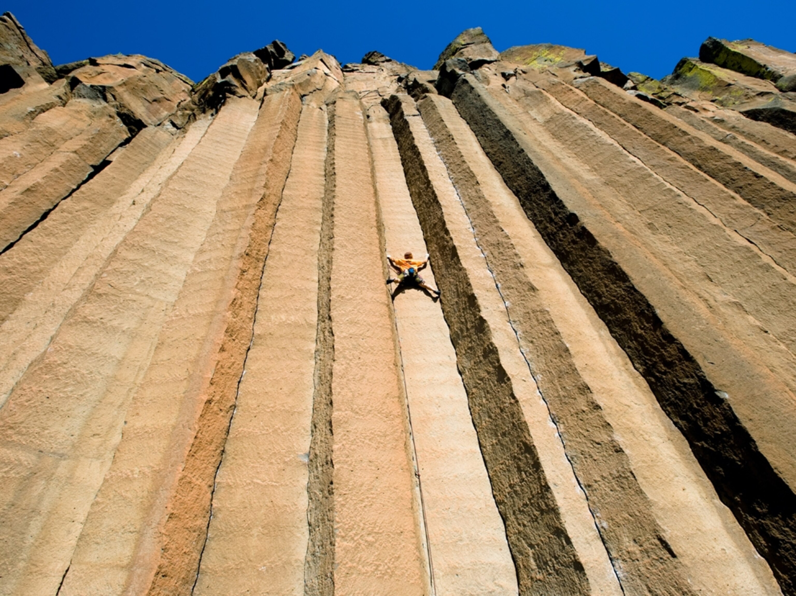 Climber on steeply vertical rock