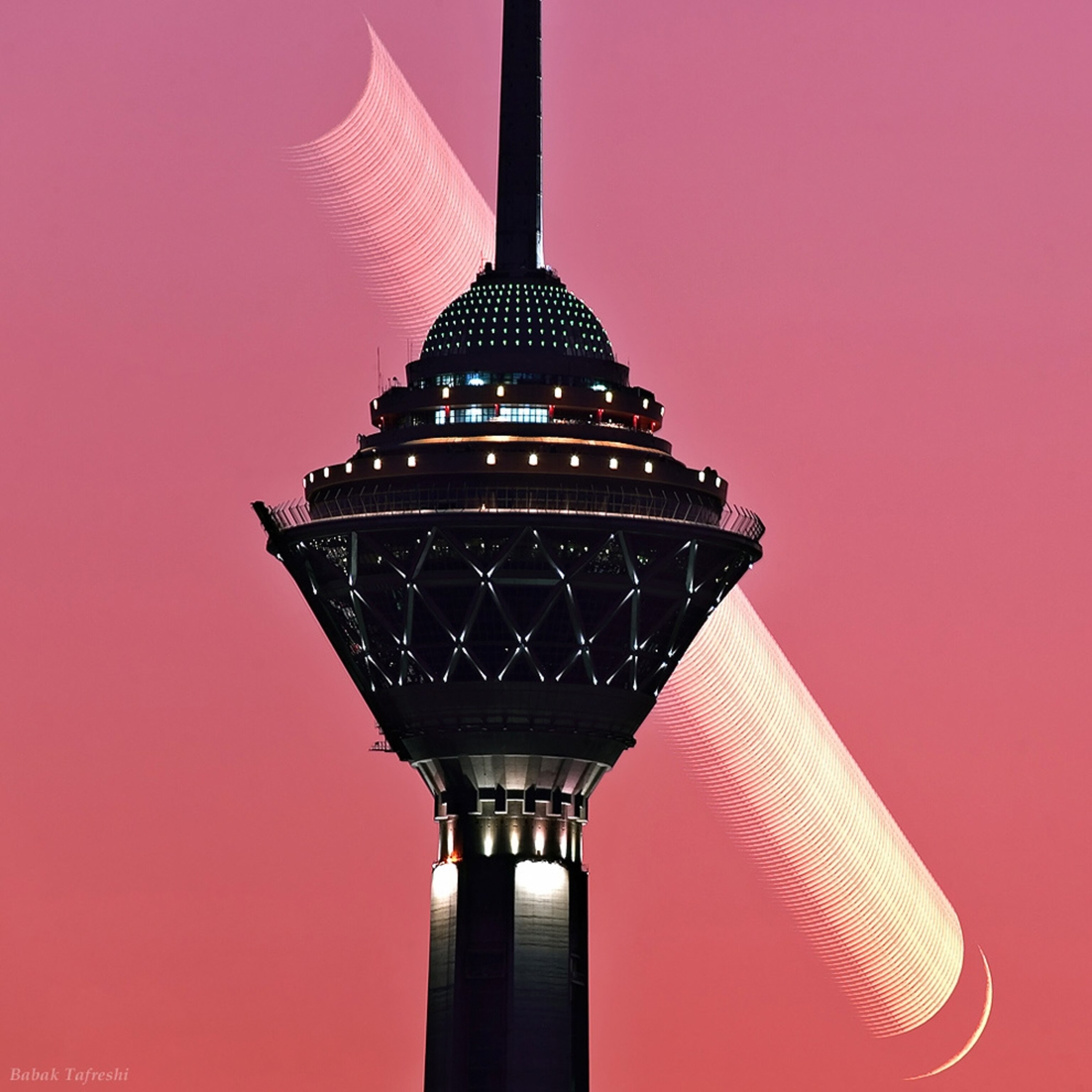 Mosaic picture of the new moon setting behind a communications tower in Iran.