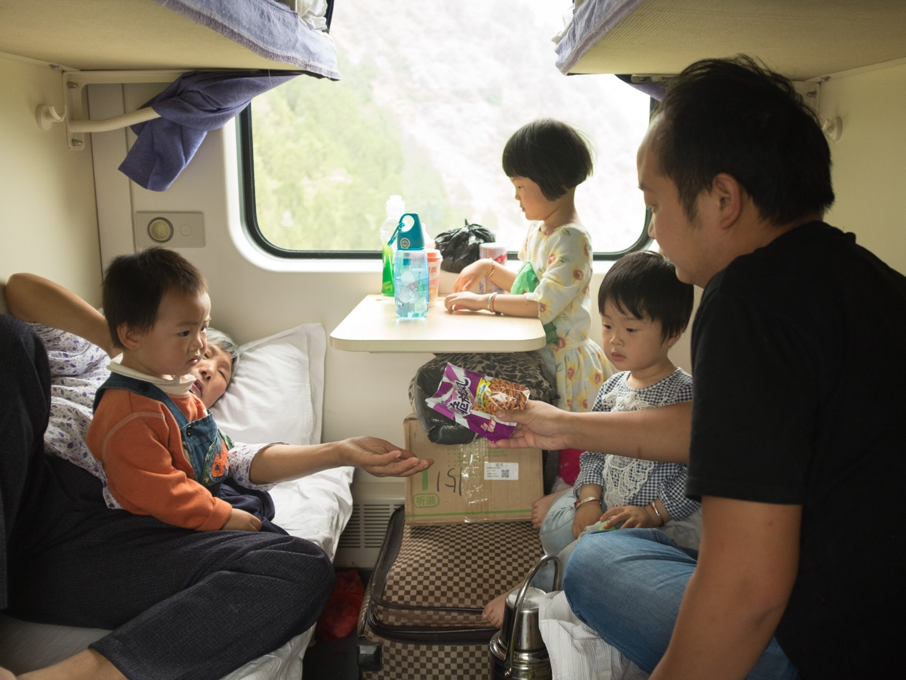 a grandmother, her son, and his three children share a snack