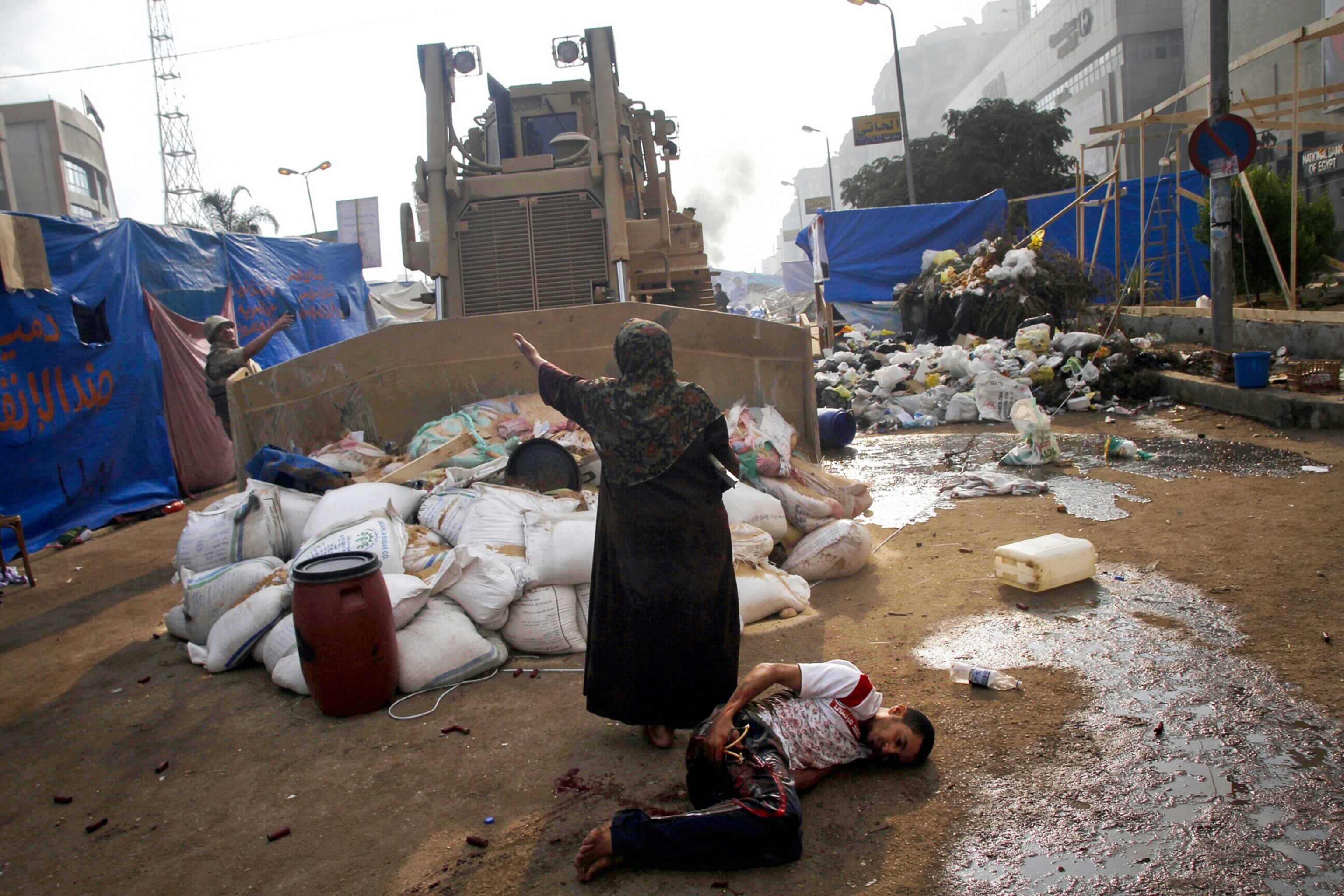 a woman confronting a bulldozer during clashes in Cairo, Egypt.