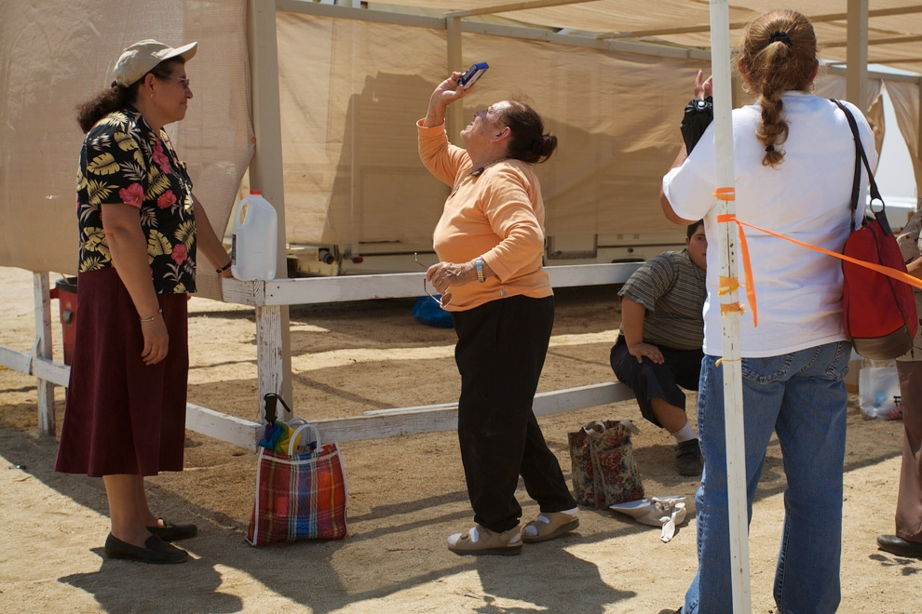 A woman photographing the sky