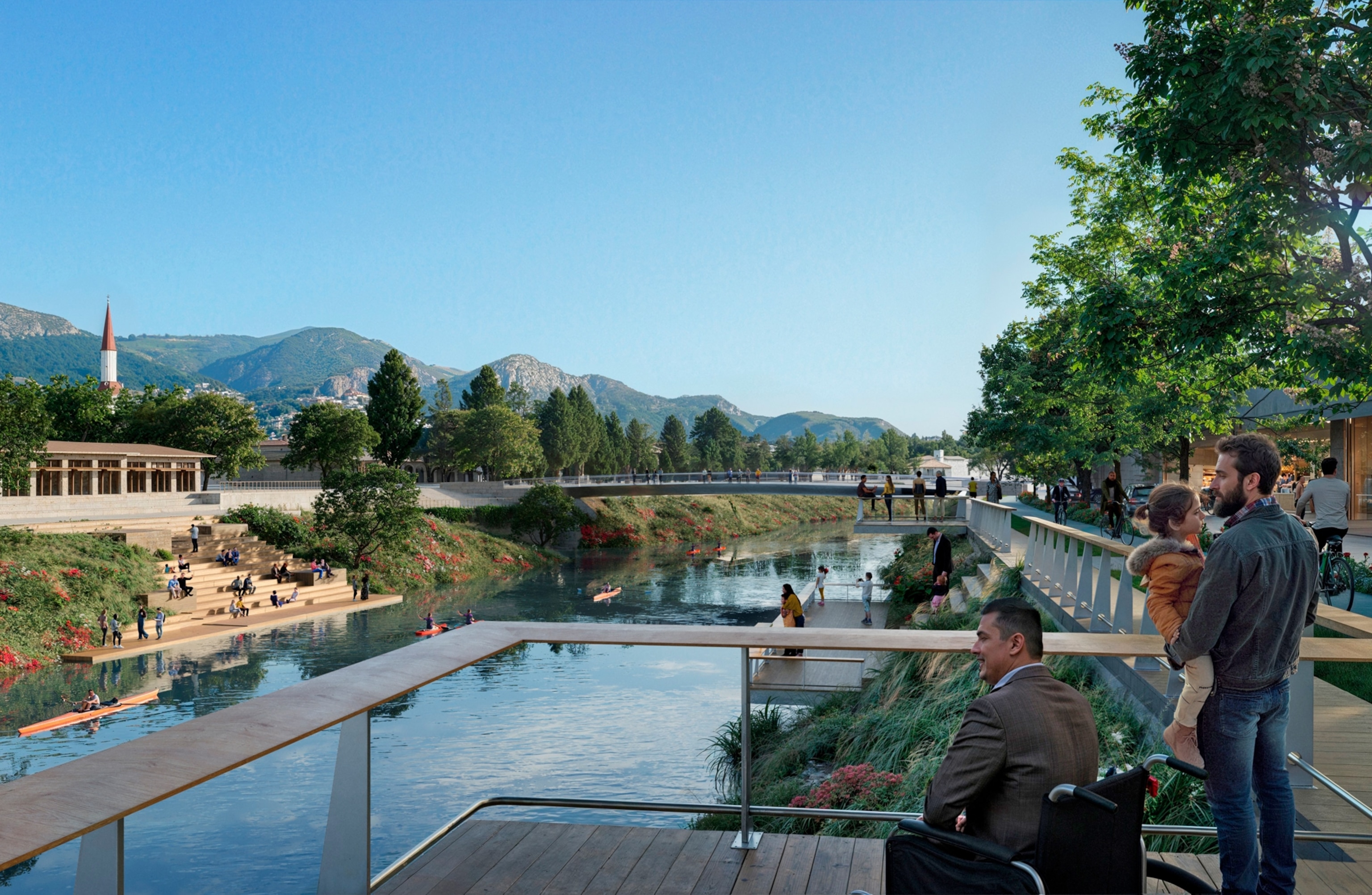 One man in wheelchair and another man holding a chile at the observation platform over river with other platforms and bridge on the background.
