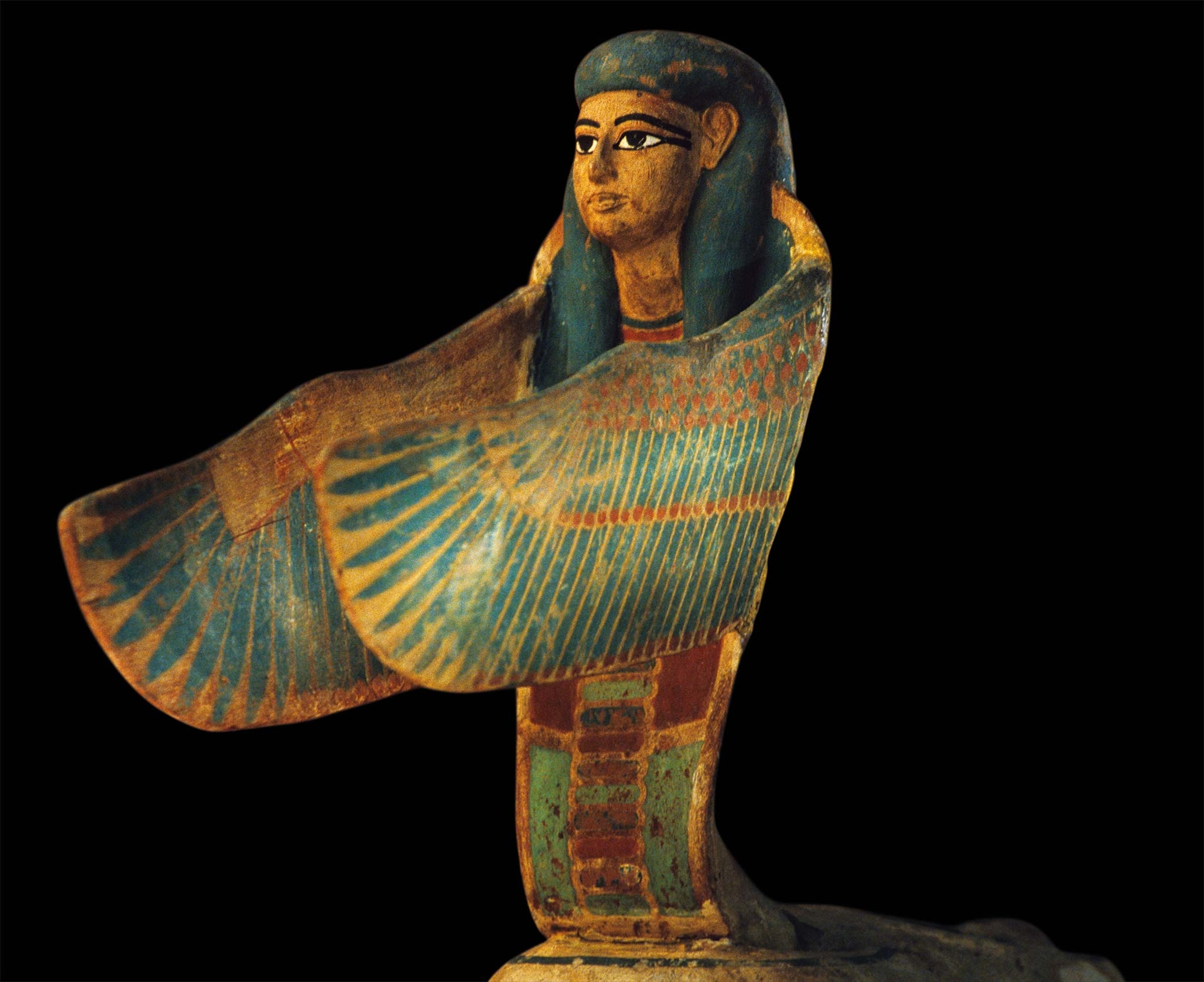 A goddess with the body of a serpent spreads her wings in an attitude of protection toward the soul of the deceased pharaoh.