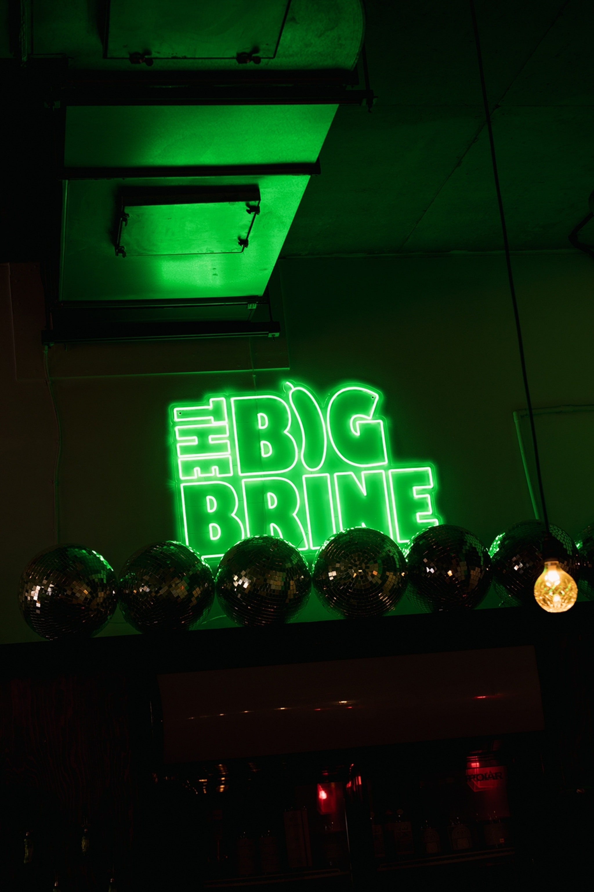 Neon green sign saying The Big Brine.