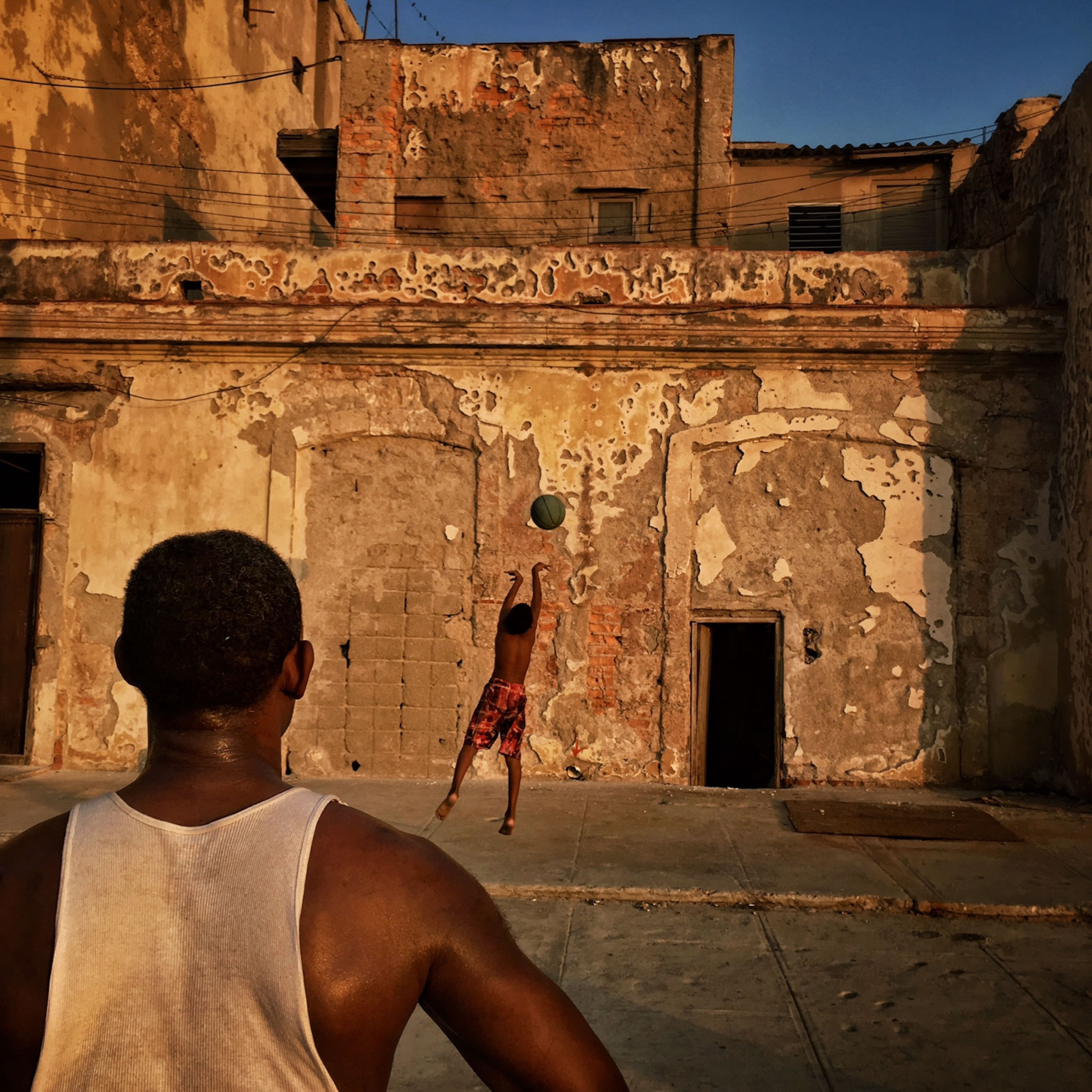 a man and a boy playing basketball in Havana, Cuba
