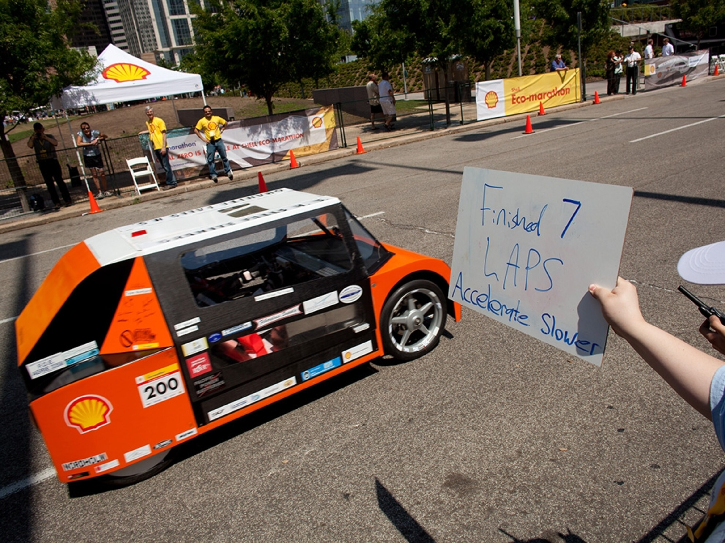 Granite Falls (Washington) High School Urban Concept car driver Aron Scalf gets instruction from his team to accelerate slower during a run on the track at the Eco-marathon.