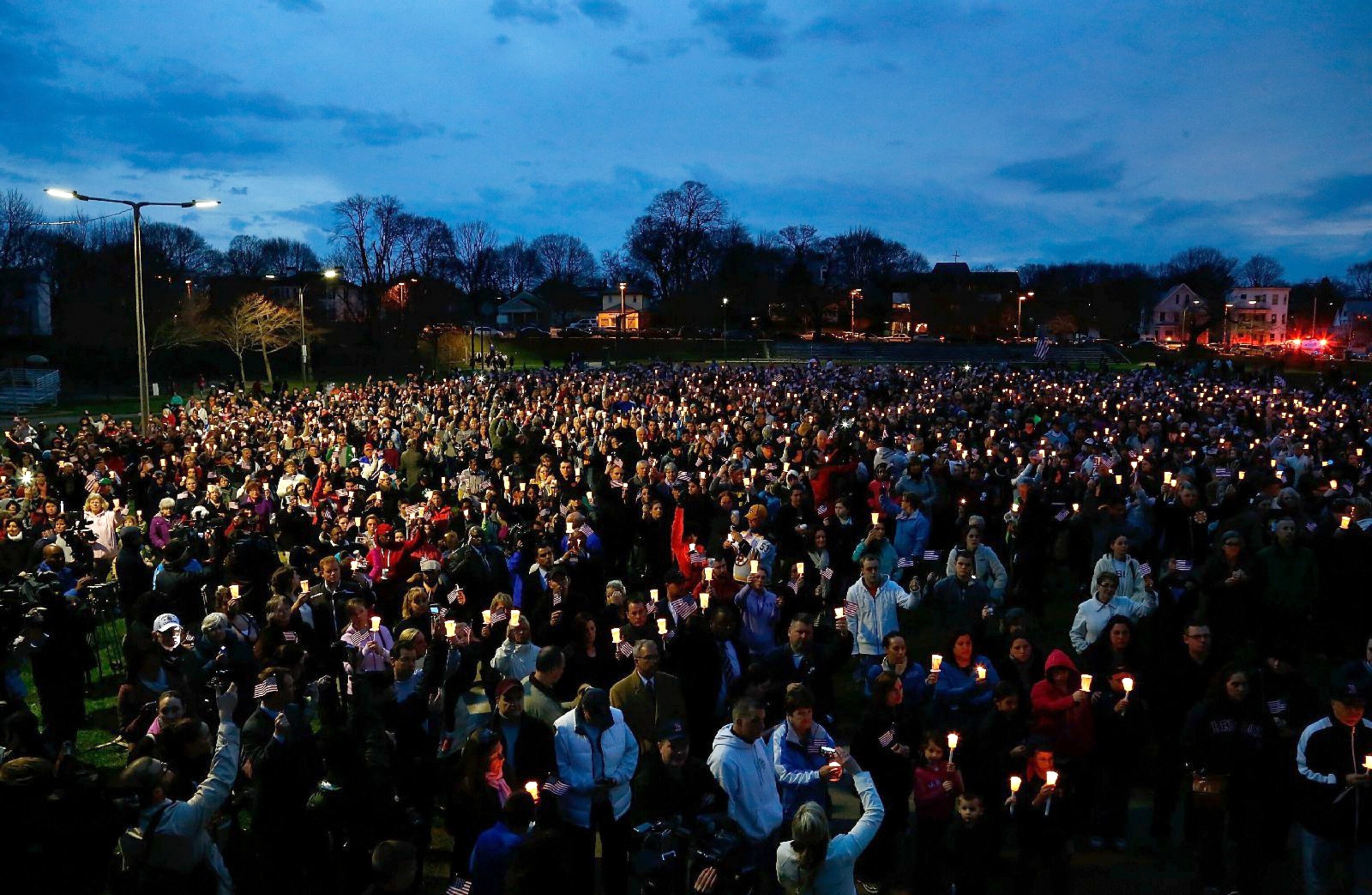 This Week in Boston - People gather with candles during a vigil for an eight-year-old that was killed in the Boston Marathon bombing.