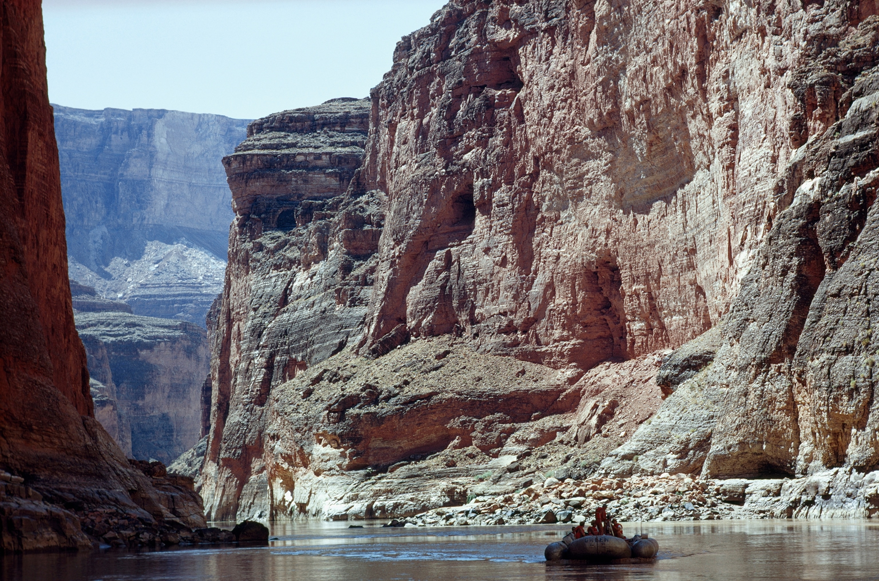 A raft drifts down placid stretch of Colorado River in Marble Canyon.