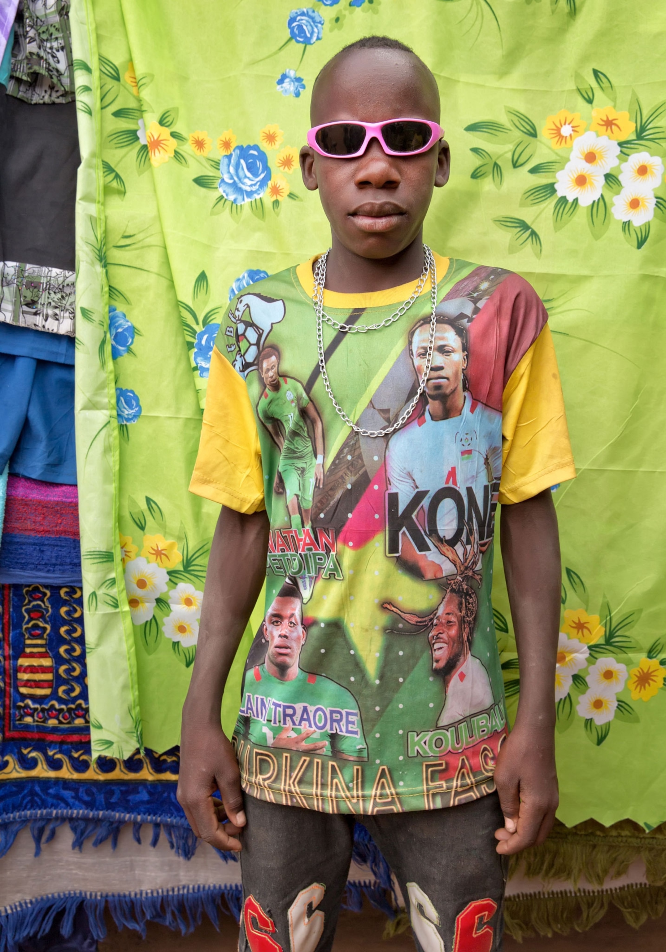 a young man shopping at an outdoor market in Burkina Faso