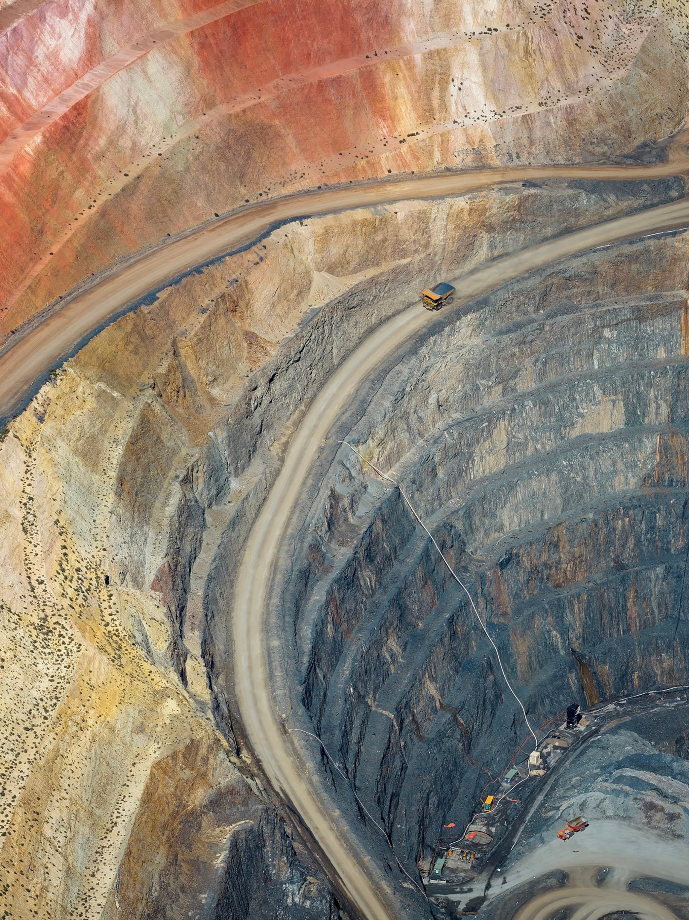 Overhead view of a rocky goldmine with a few roads carved into it.