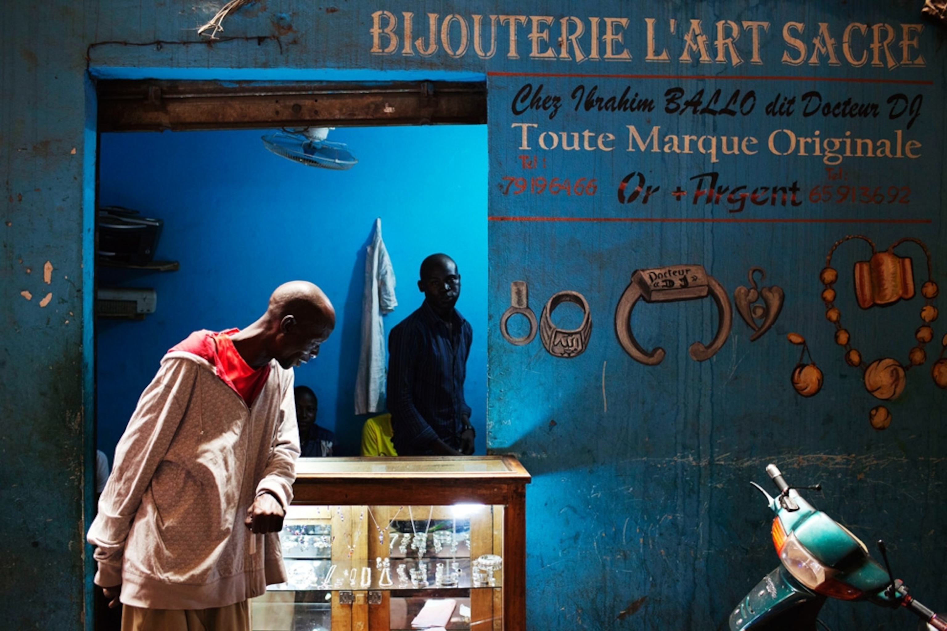 Pictures We Love August - A picture of a man looking at jewelry.