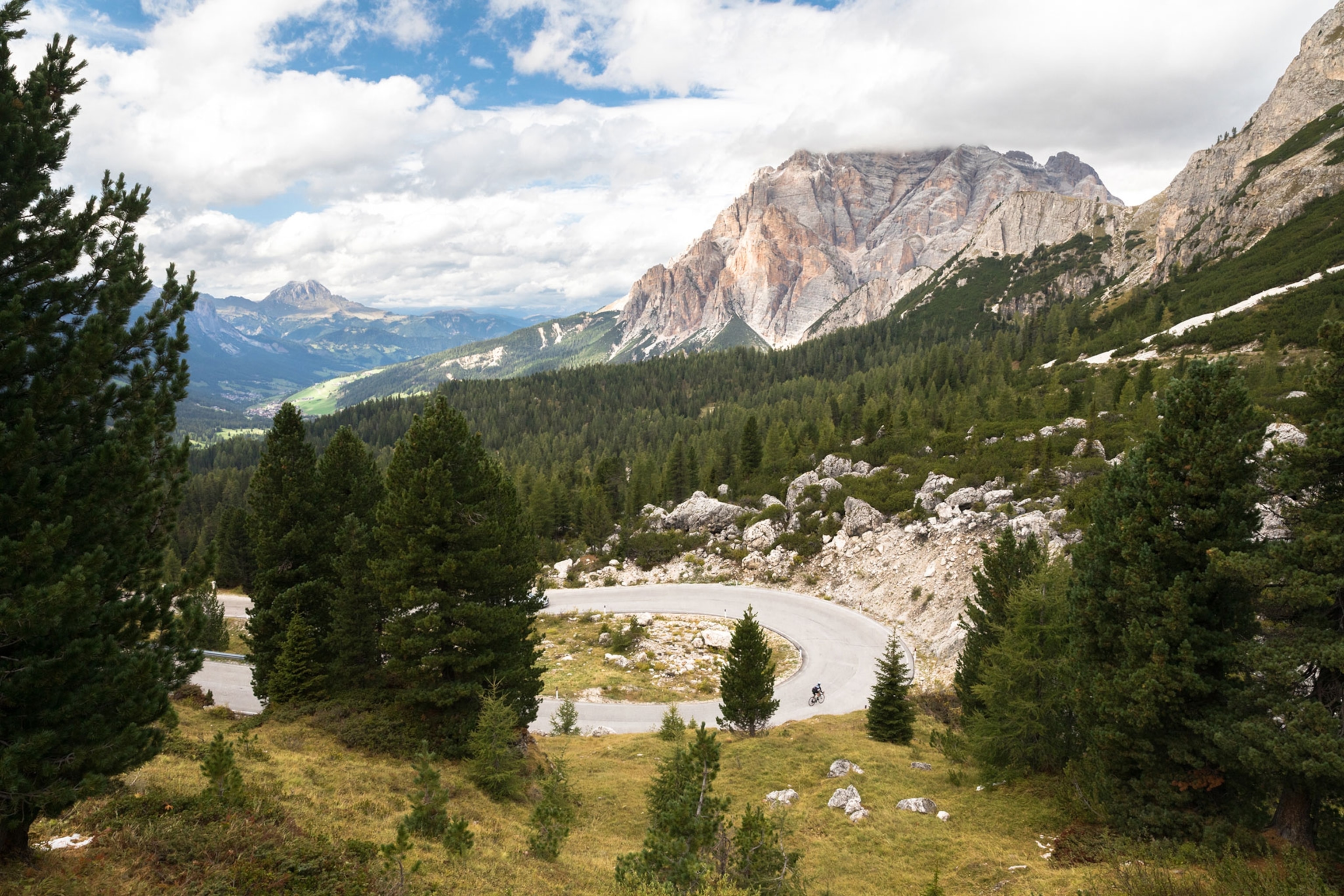 a cyclist riding through the Dolomites of Italy