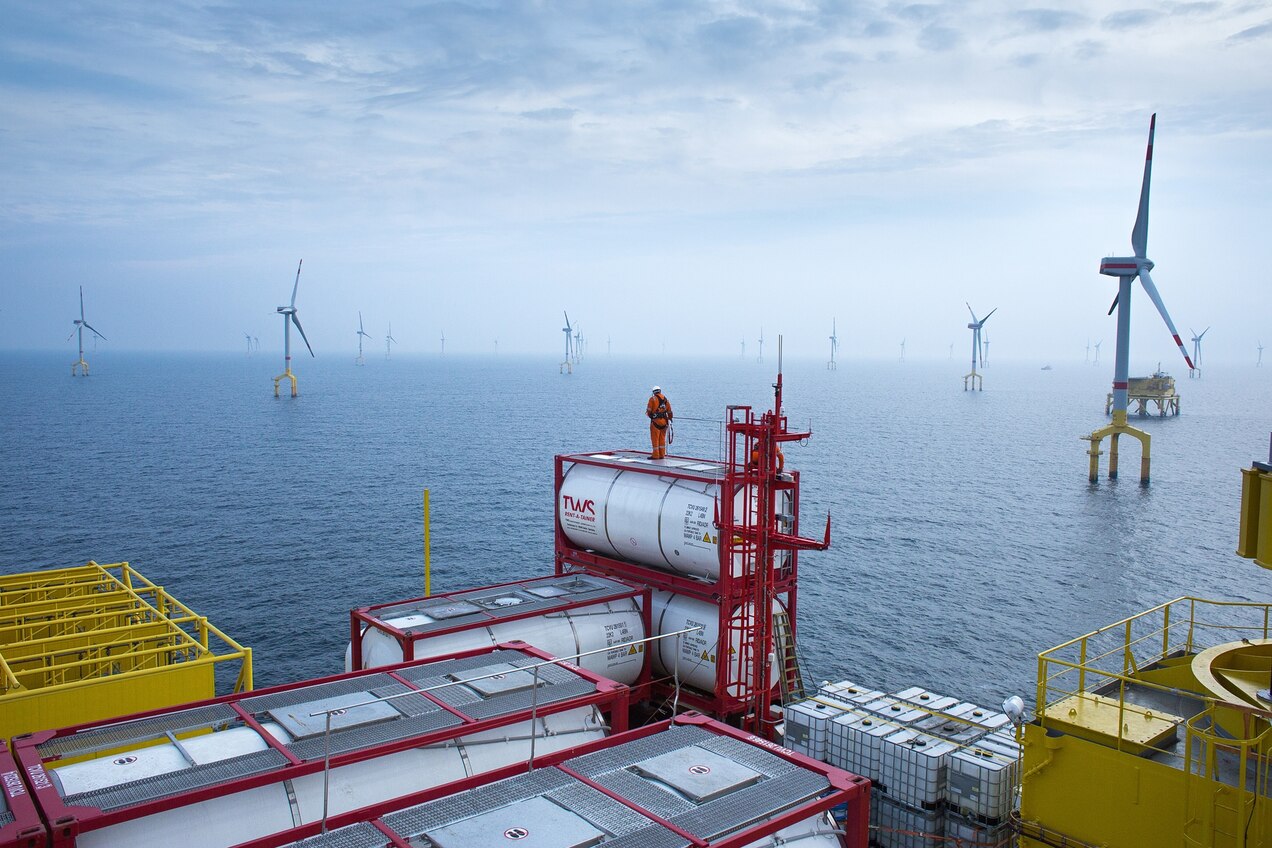 Riggers secure containers on the HVDC converter platform