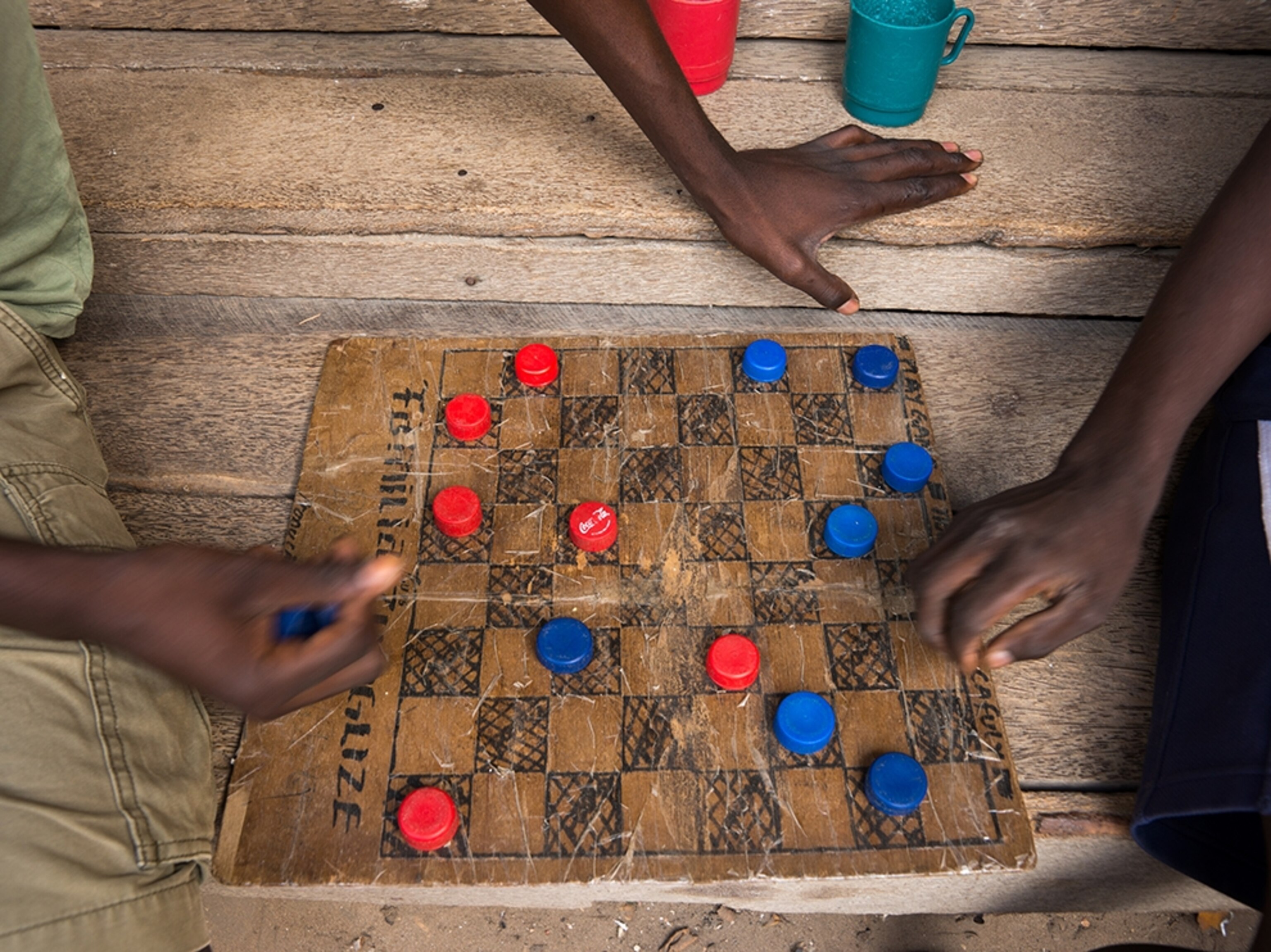 people playing checkers at the local market of Vilankulo, in Mozambique.