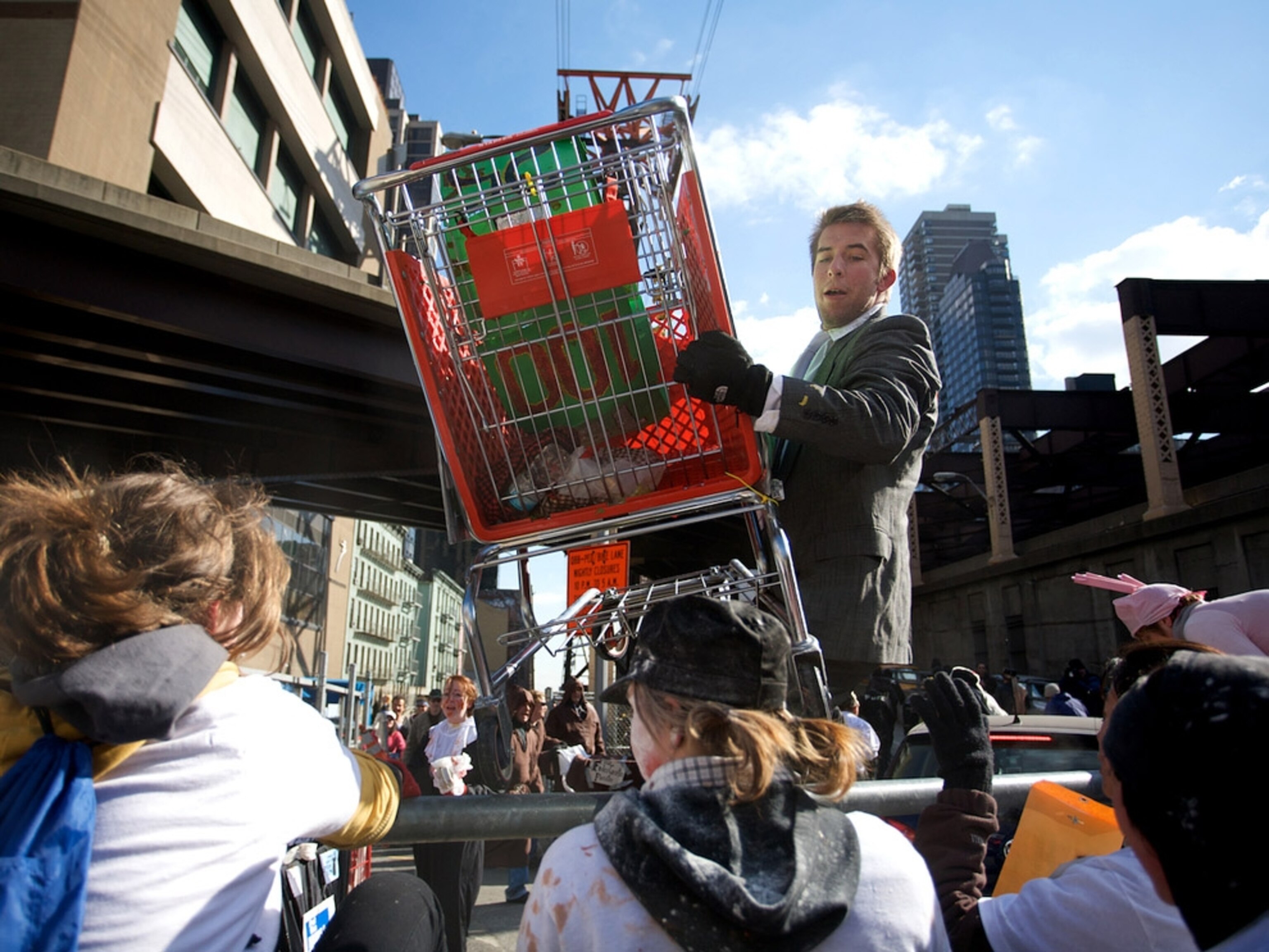 Suited man passing shopping cart over a median