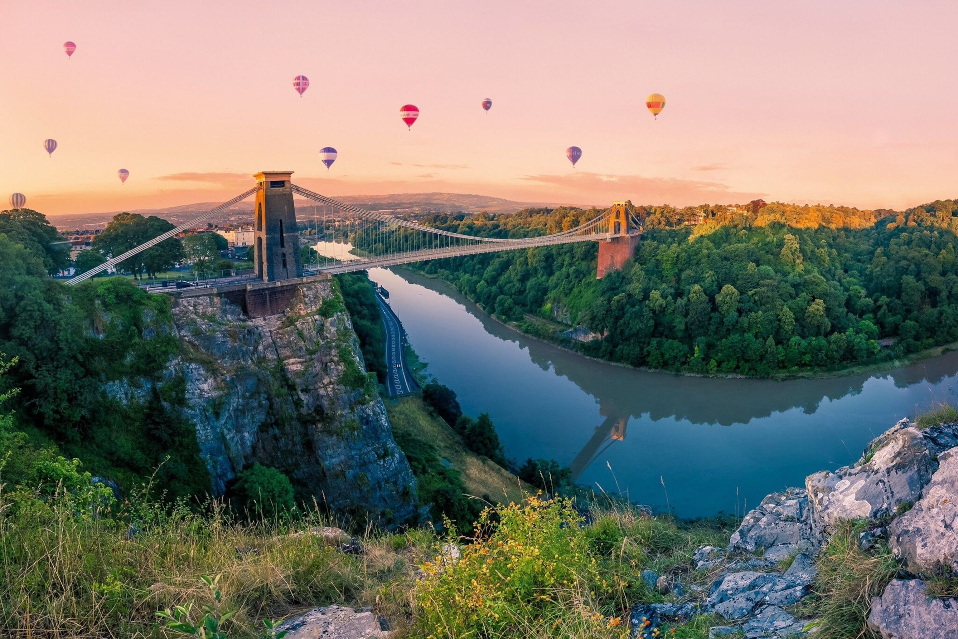 Hot air balloons at sunrise over Clifton Suspension Bridge, Bristol.