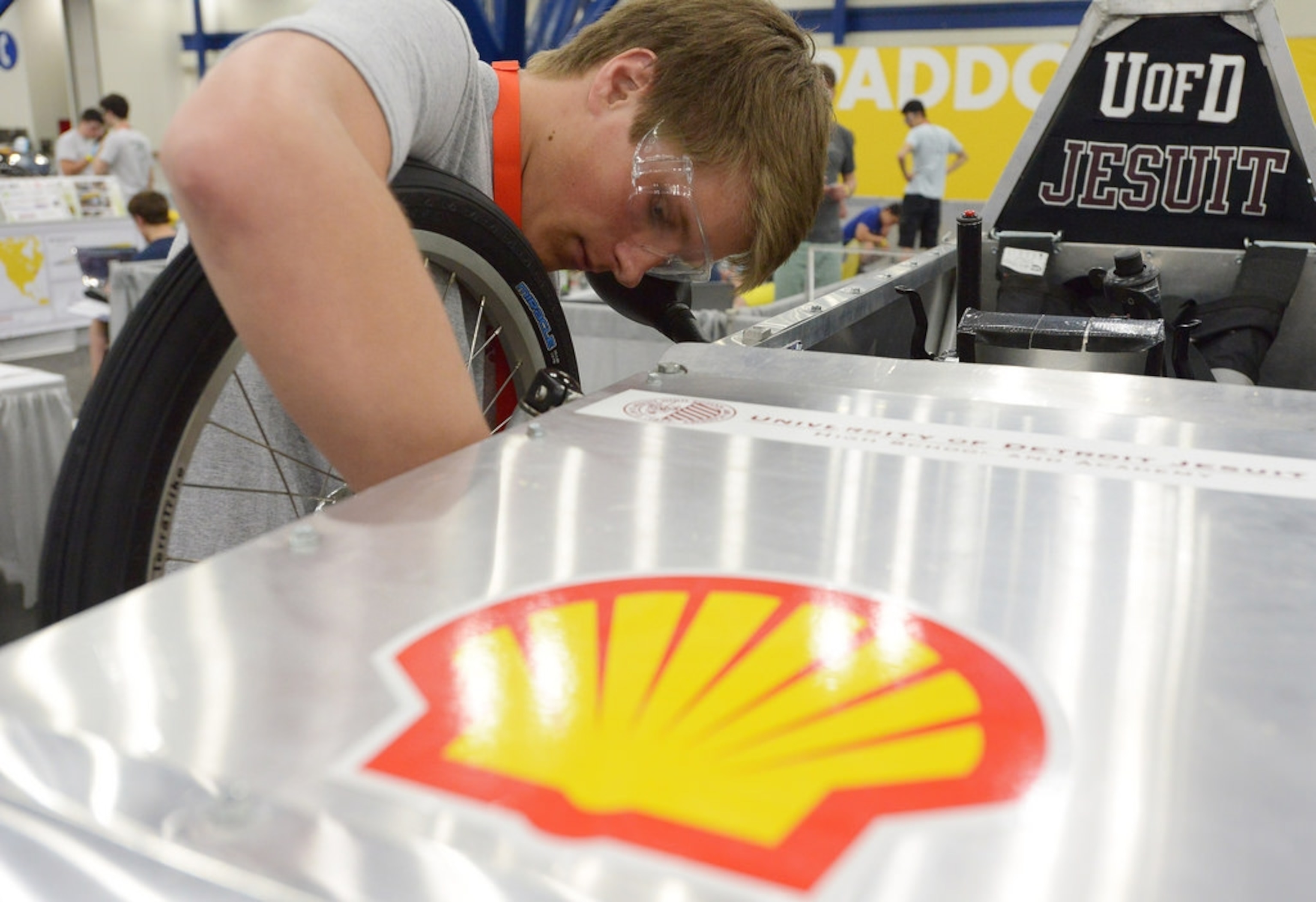 University of Detroit Jesuit High School team leader Jacob Byrd tinkers with the battery-powered Electric Motor City Cub prototype Saturday at the Shell Eco-marathon Americas competition. Photo courtesy of Shell Eco-marathon.