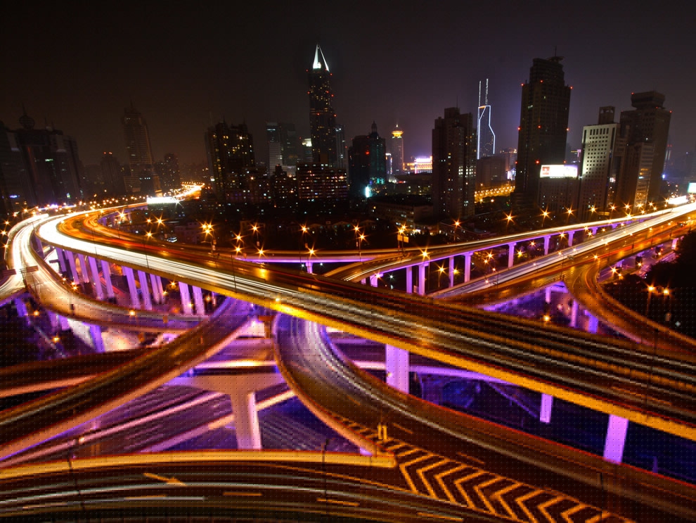 Cars traveling on winding highways at night