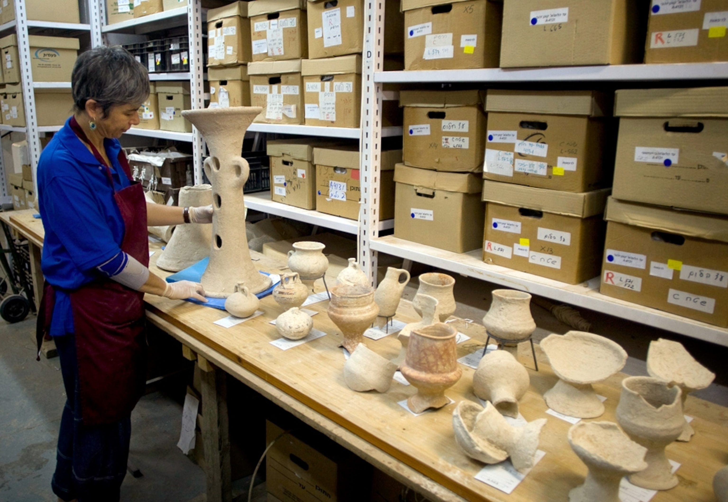 A picture of a conservator preserving pagan artifacts found recently in Israel