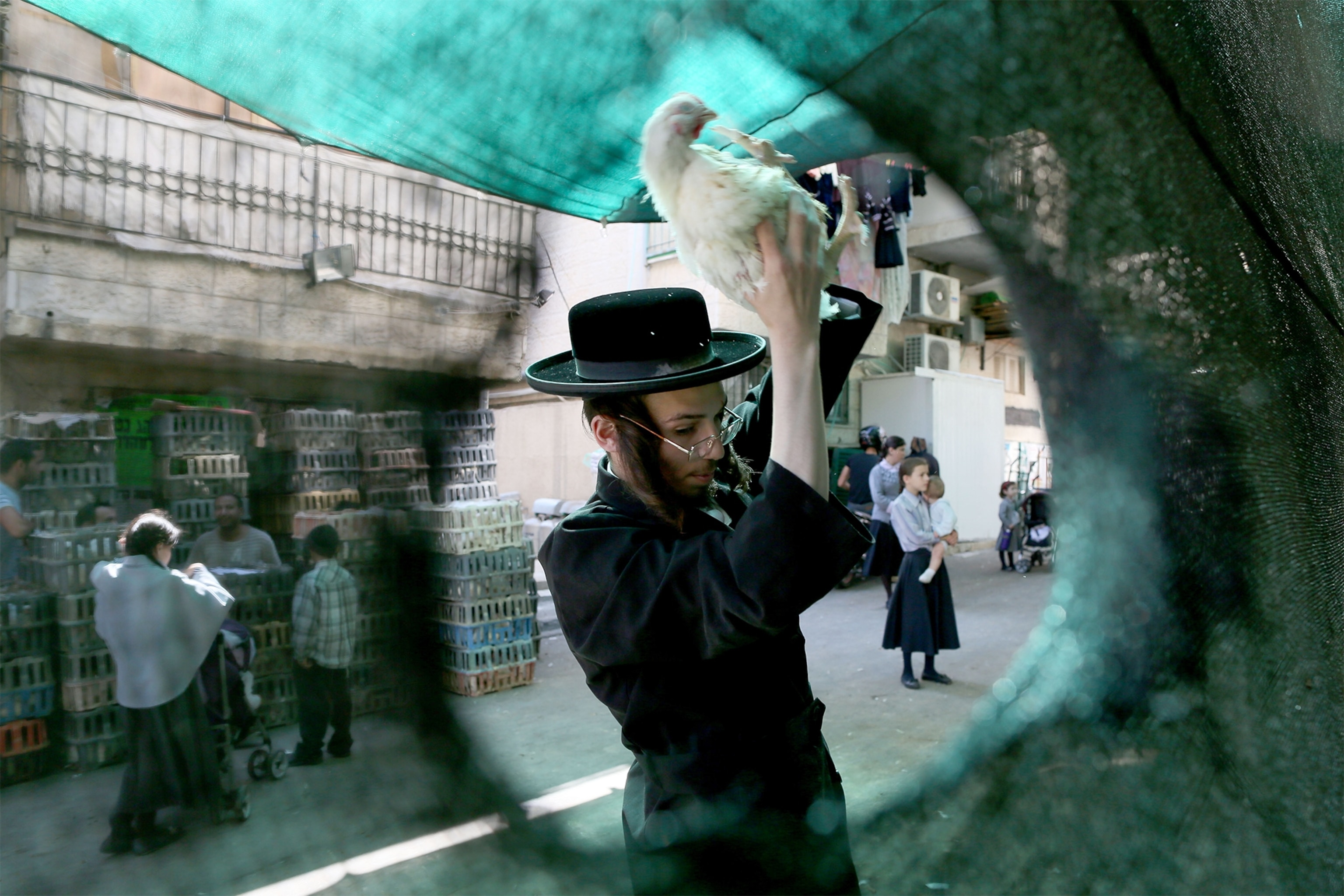 An Ultra Orthodox man waves a chicken over his head which is part of the tradition of transferring sins from the past year into the chicken.