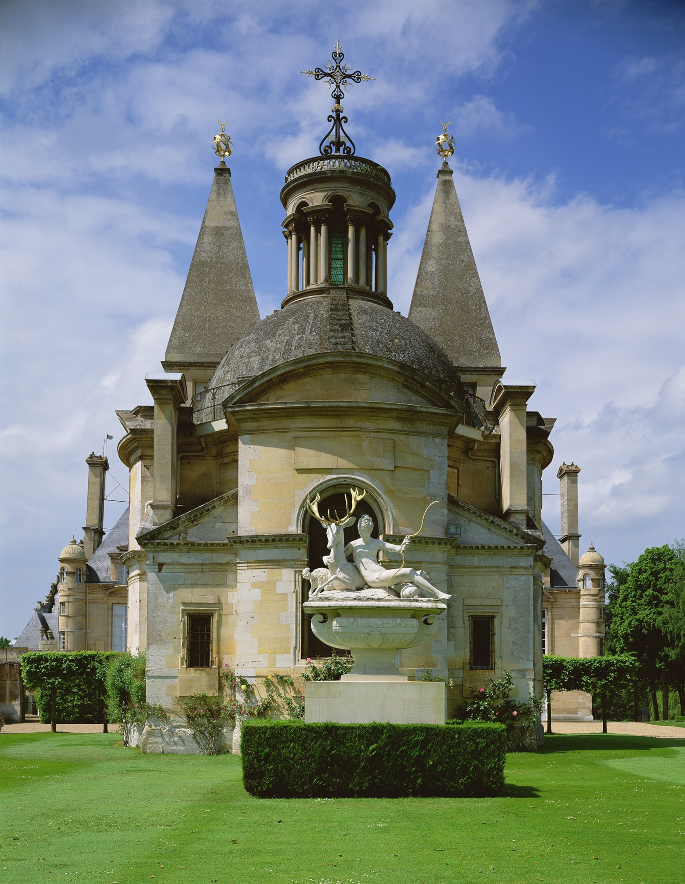 A statue in front of a chapel showing a woman as a hunter.