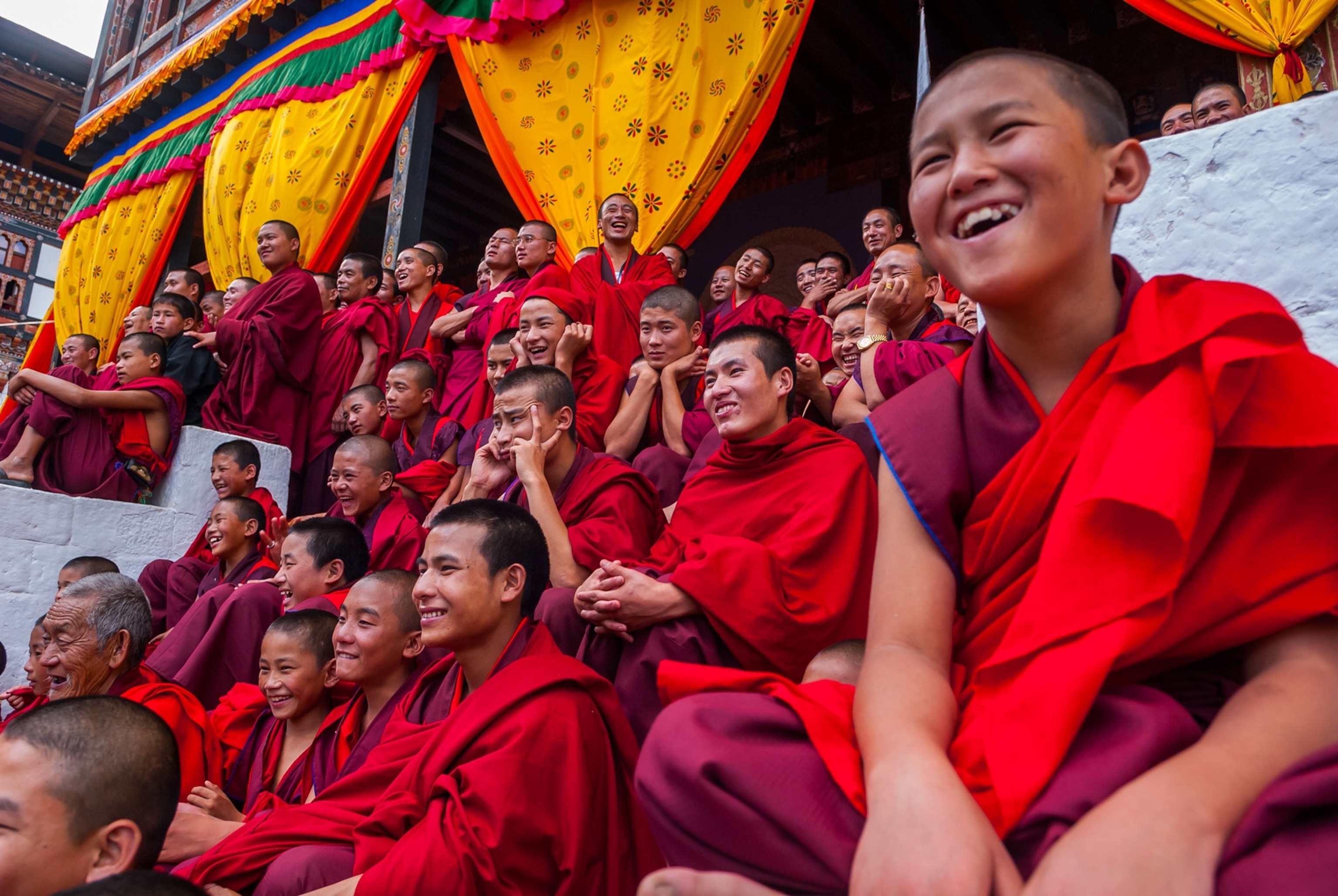 monks enjoying a performance in Bhutan