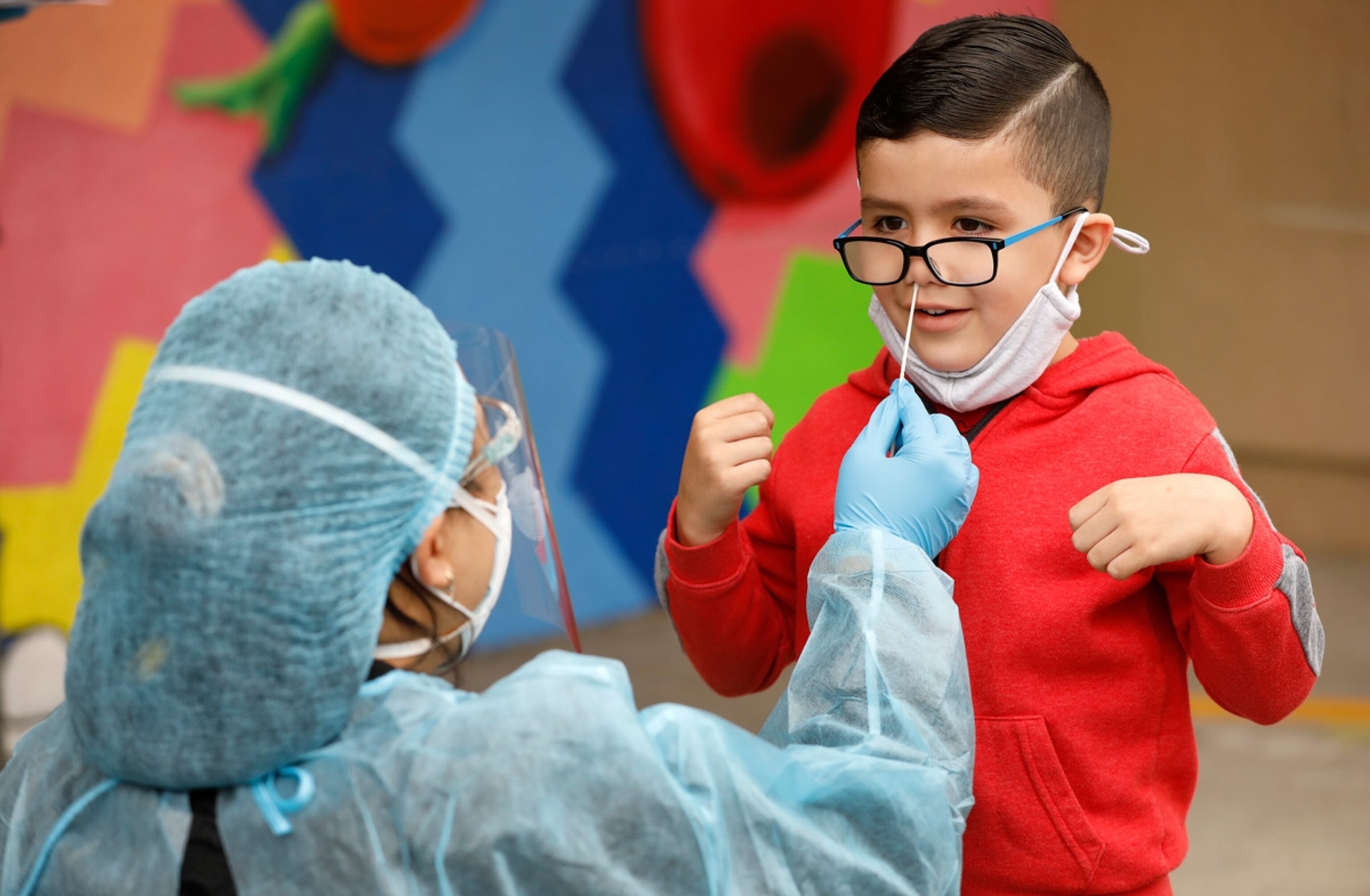 Kindergarten student Matteo Rodriguez gets a Covid-19 test from EMT Claire Chou which will be conducted weekly as he is on the campus of Heliotrope Avenue Elementary School in Maywood Tuesday morning as some students are attending a LAUSD campus for the first time in more than a year, as some Los Angeles Unified schools reopen for in-person classes, with safety standards and mandatory COVID-19 testing of students in place. Heliotrope Avenue Elementary School on Tuesday, April 13, 2021 in Maywood, CA.