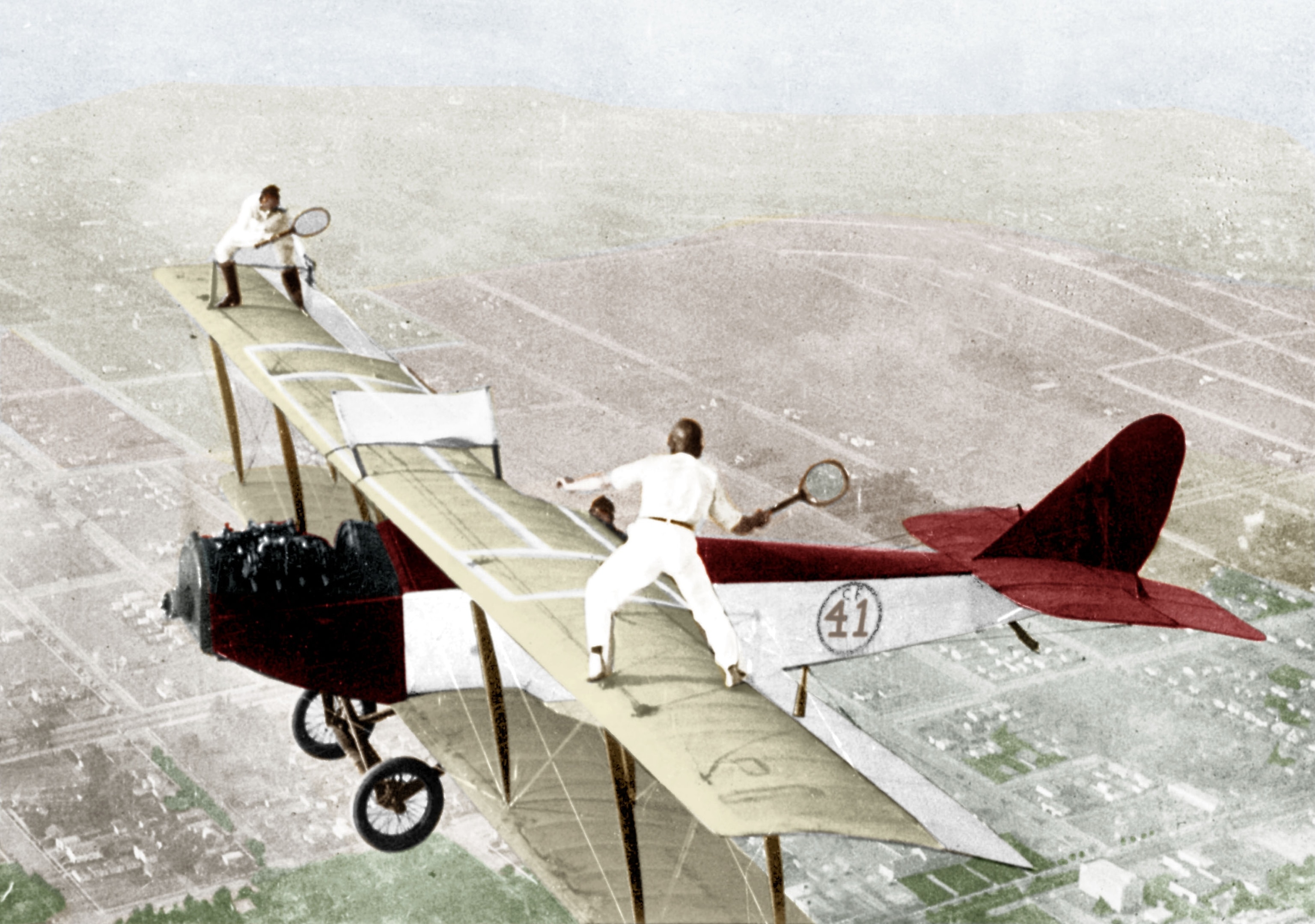 Ivan Unger and Gladys Roy playing tennis on the roof of a flying Curtiss JN-4 "Jenny" plane 1925 colourized document