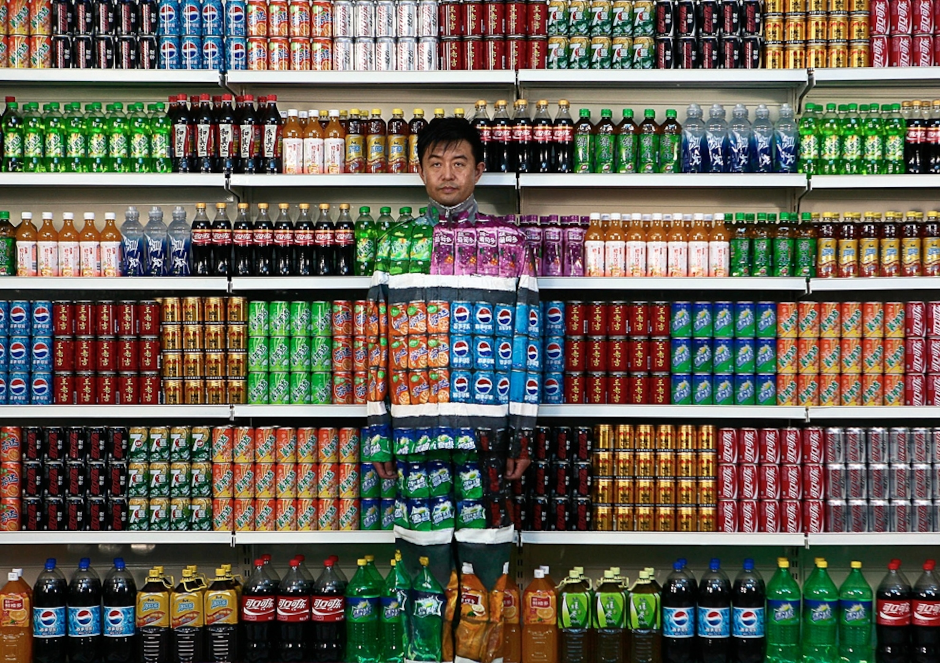 Art picture: man blending into rows of soft drinks -- for best pictures of August photo gallery