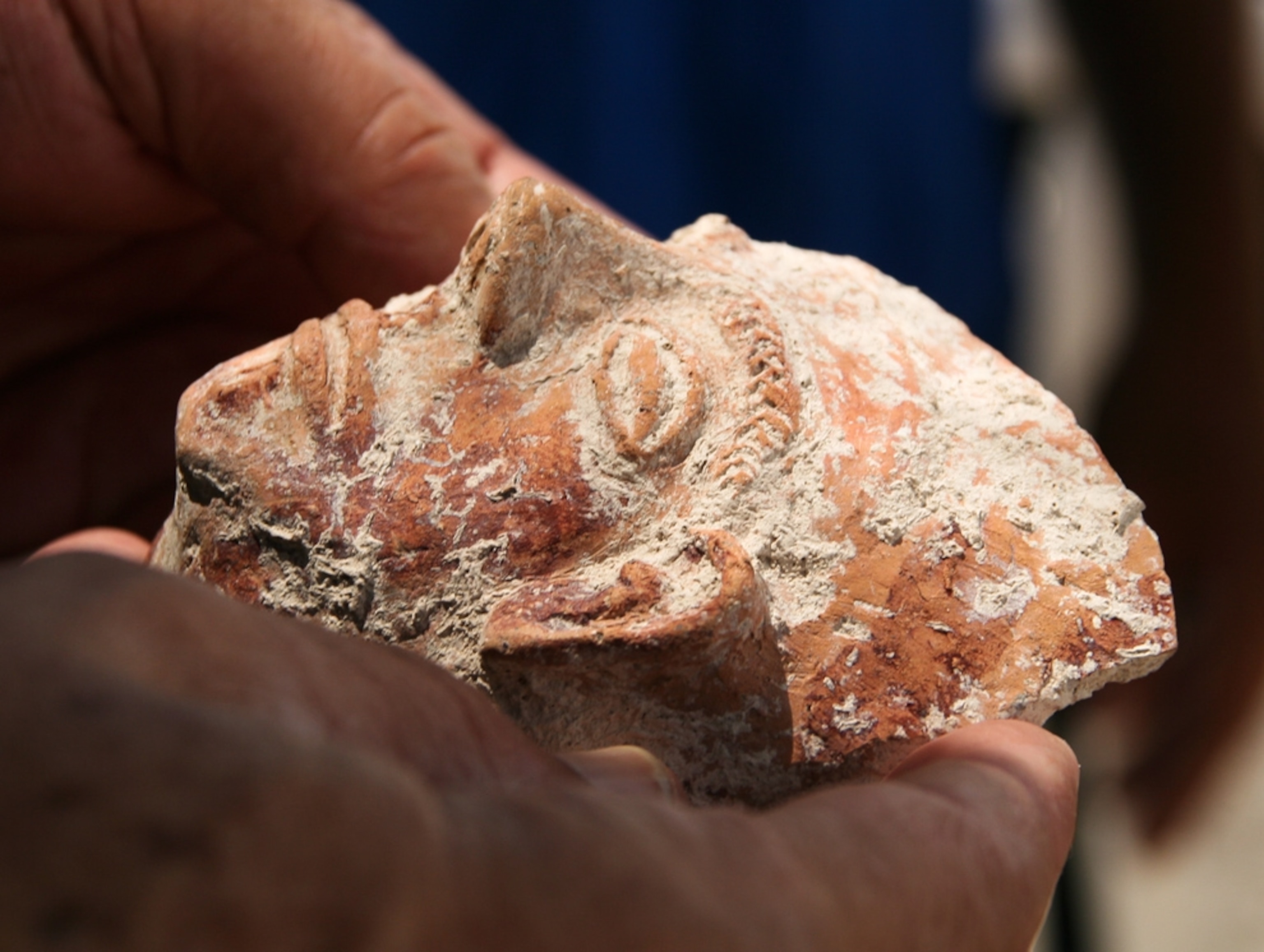 A close-up picture of a cup carved with a face, one of 200 pagan cult objects found in Israel