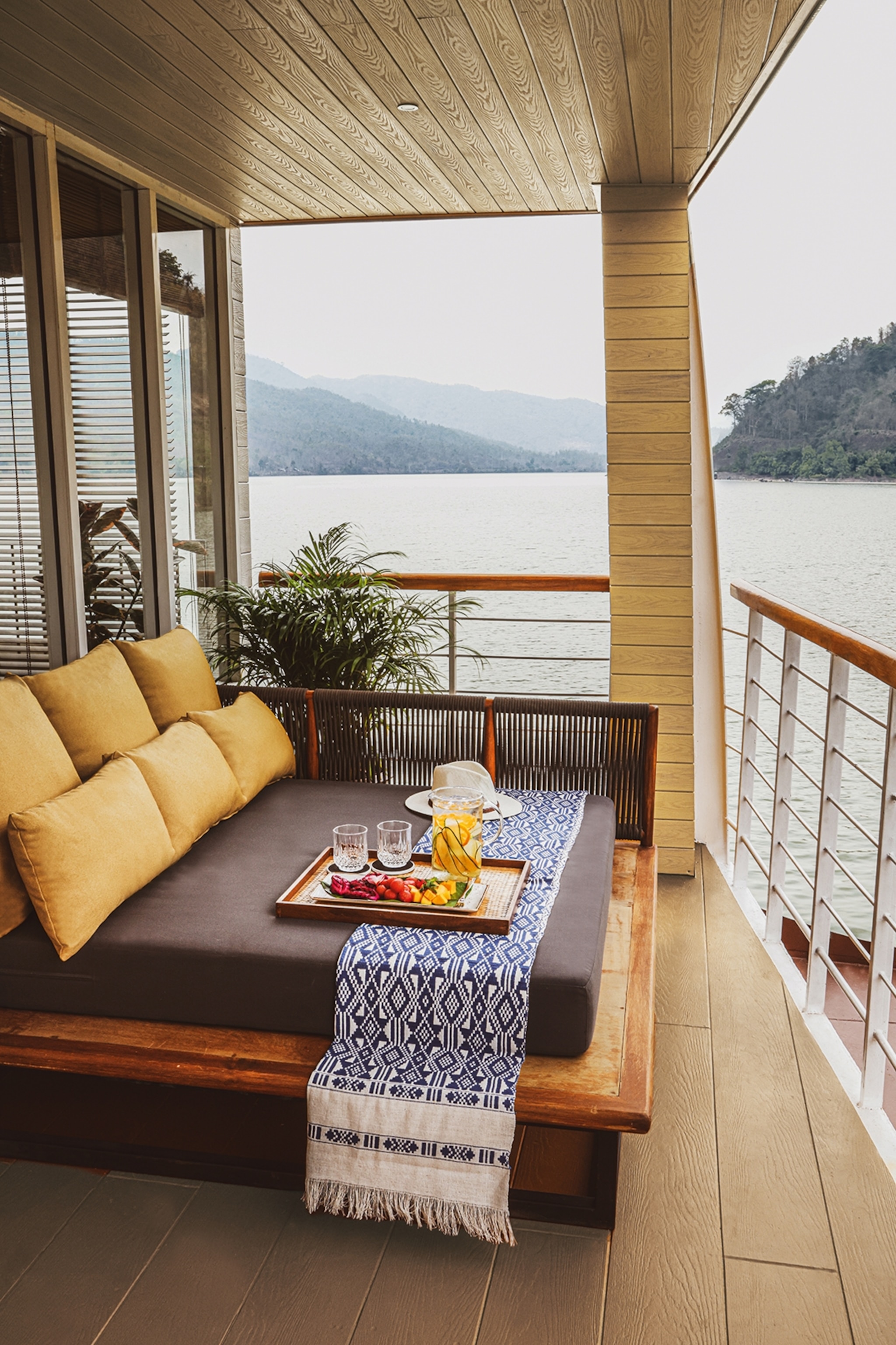 The boat balcony of a suite with a wide outdoors bed.
