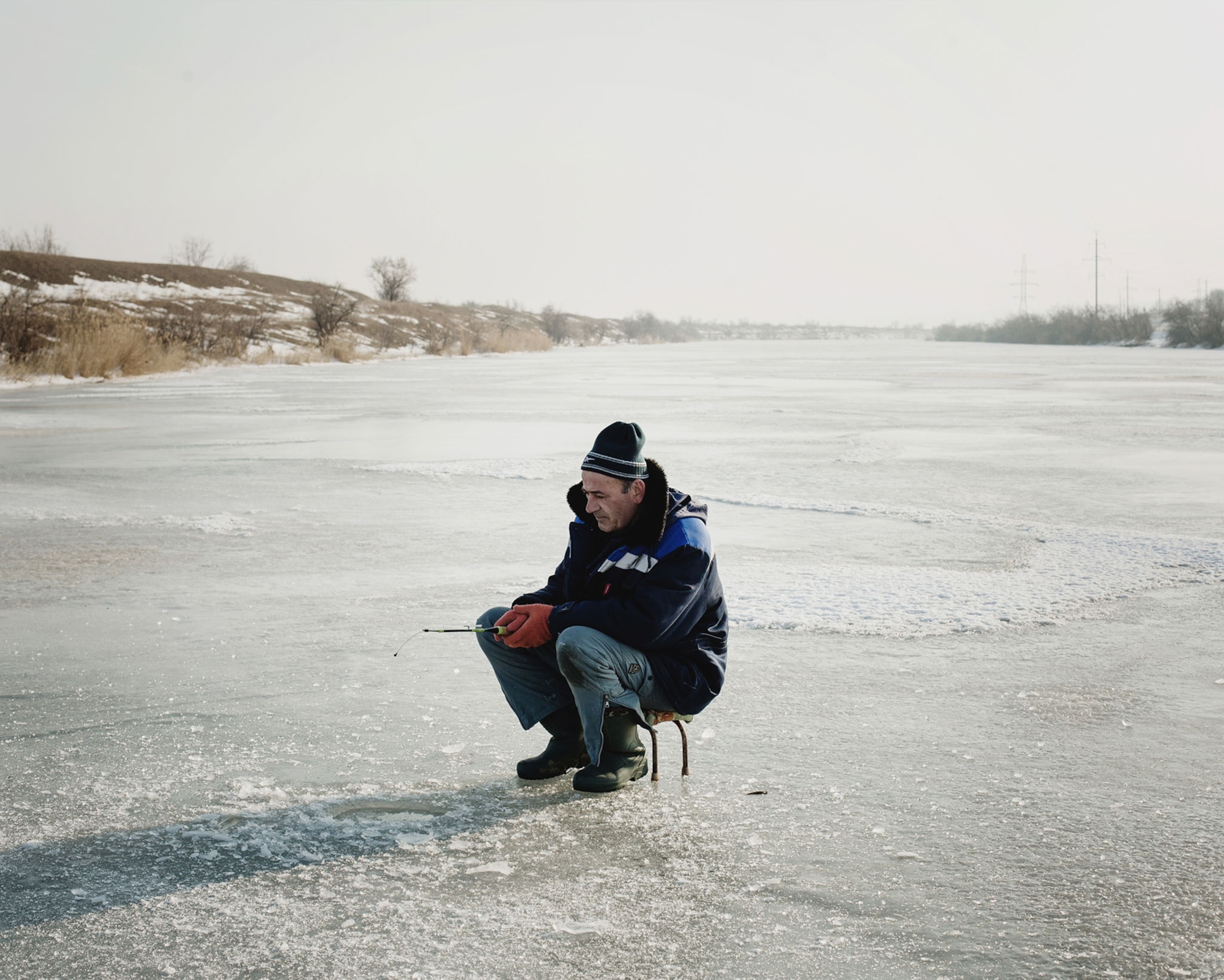 a man ice fishing