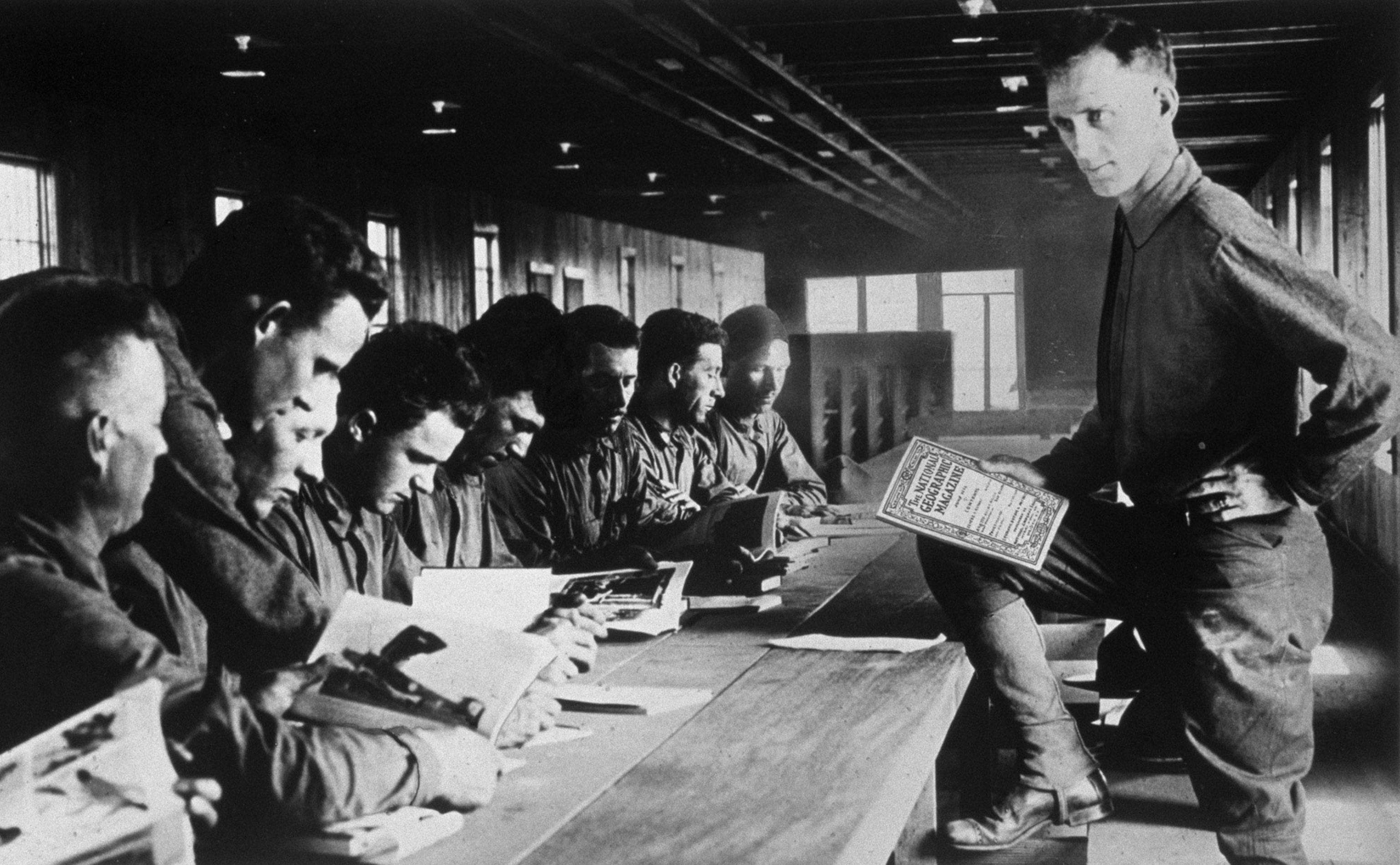 a man teaching using National Geographic Magazine