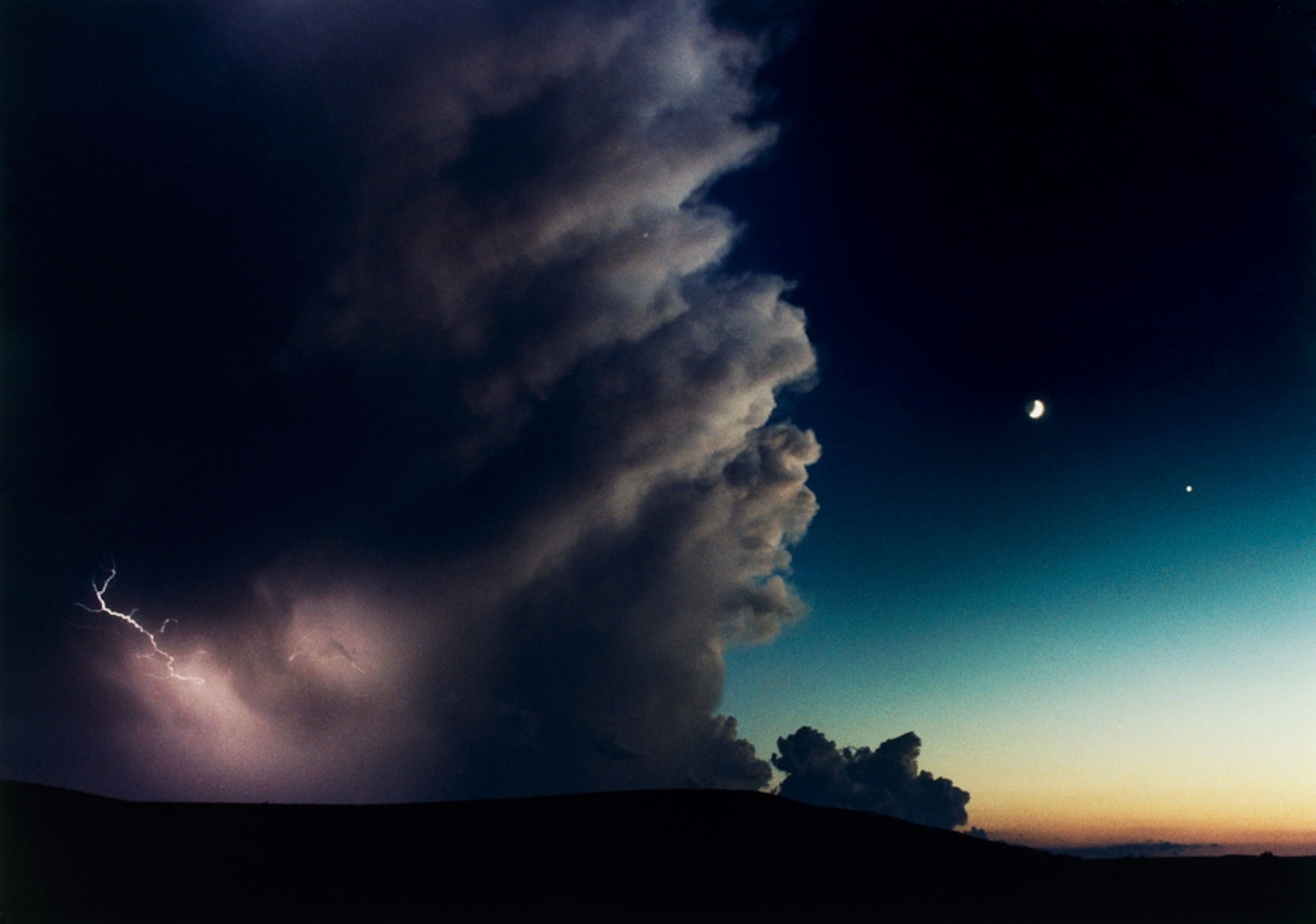a thunderstorm, lightning, and crescent moon