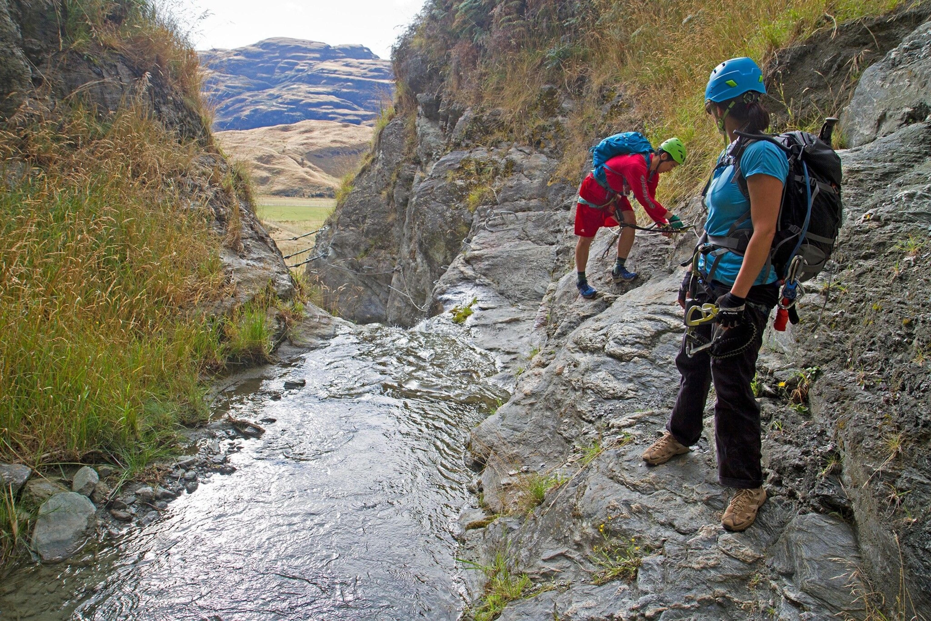Two climbers ascend Twin Falls, near Wanaka, New Zealand.