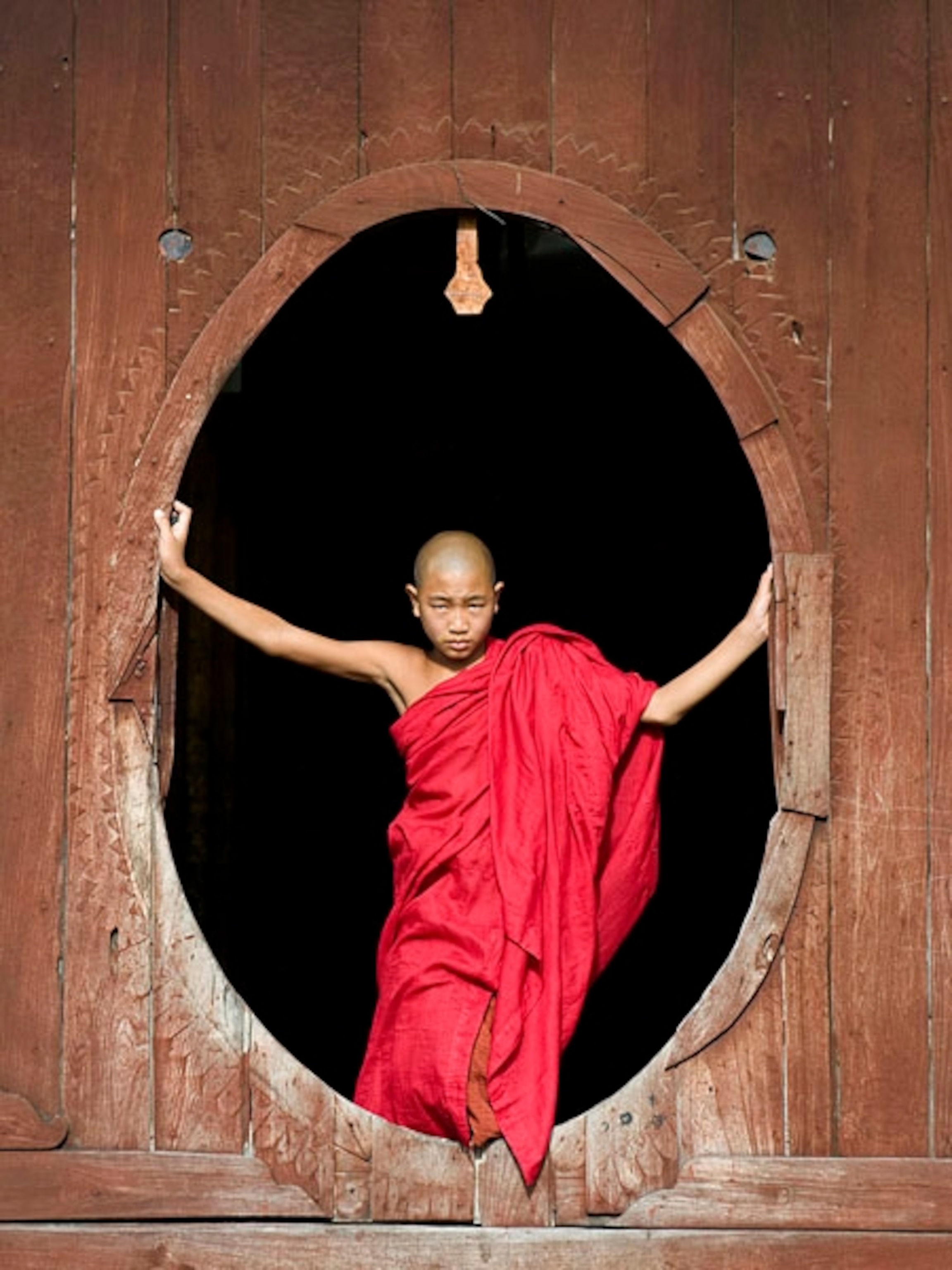 Monk standing in an oval-shaped window