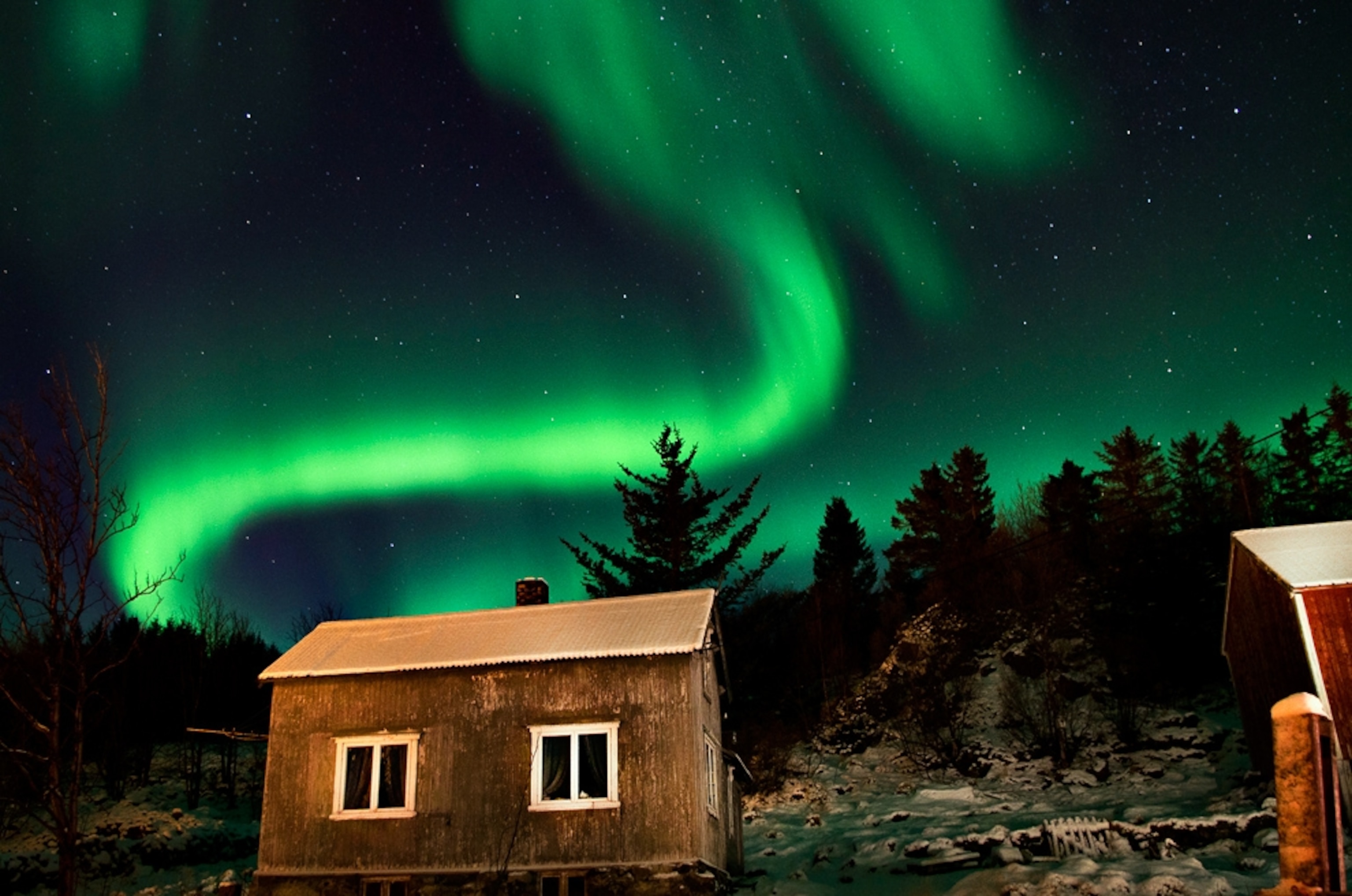 Aurora picture: northern lights over houses in Norway
