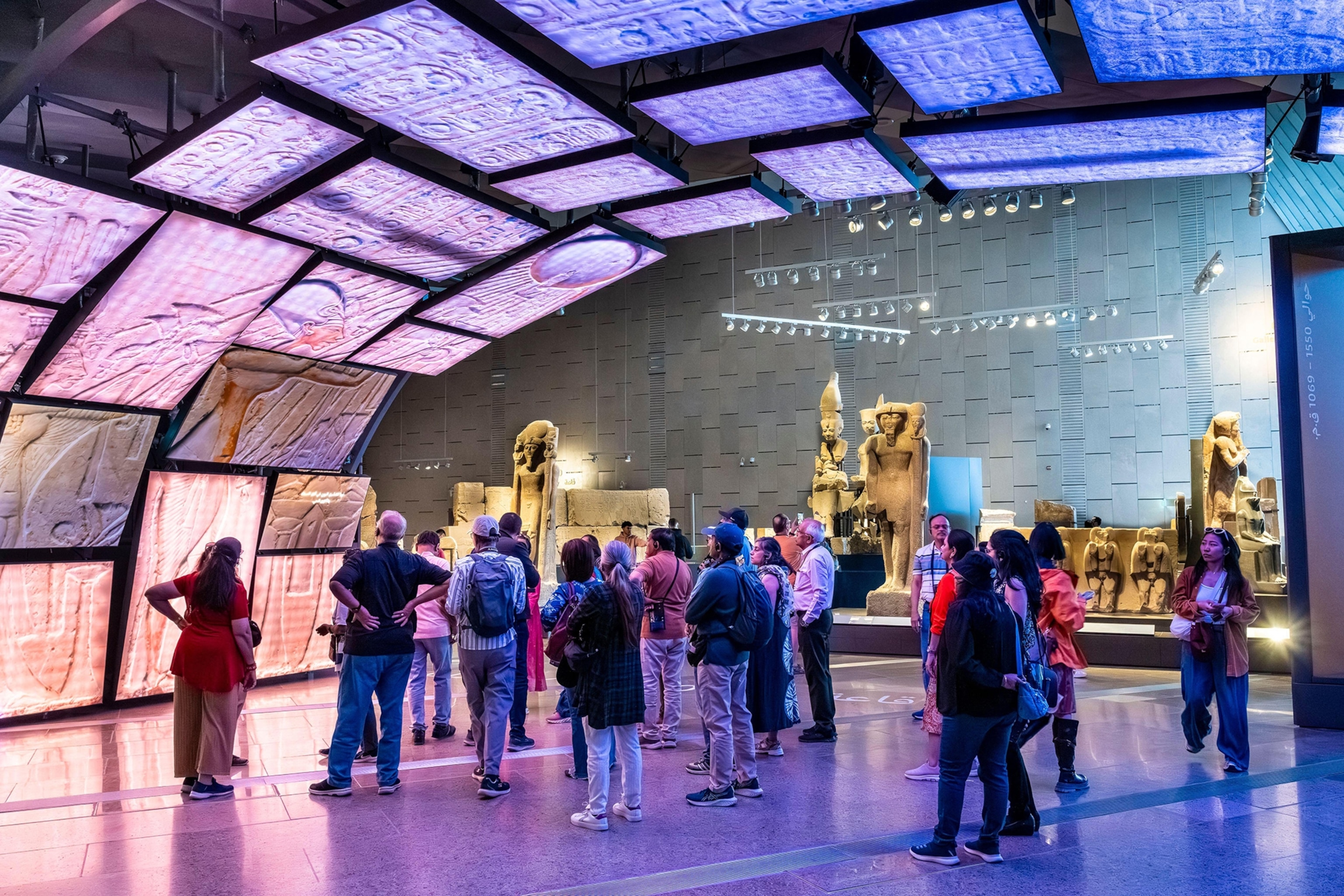 An arched hall with stone plates featuring ancient Egyptian hieroglyphs.