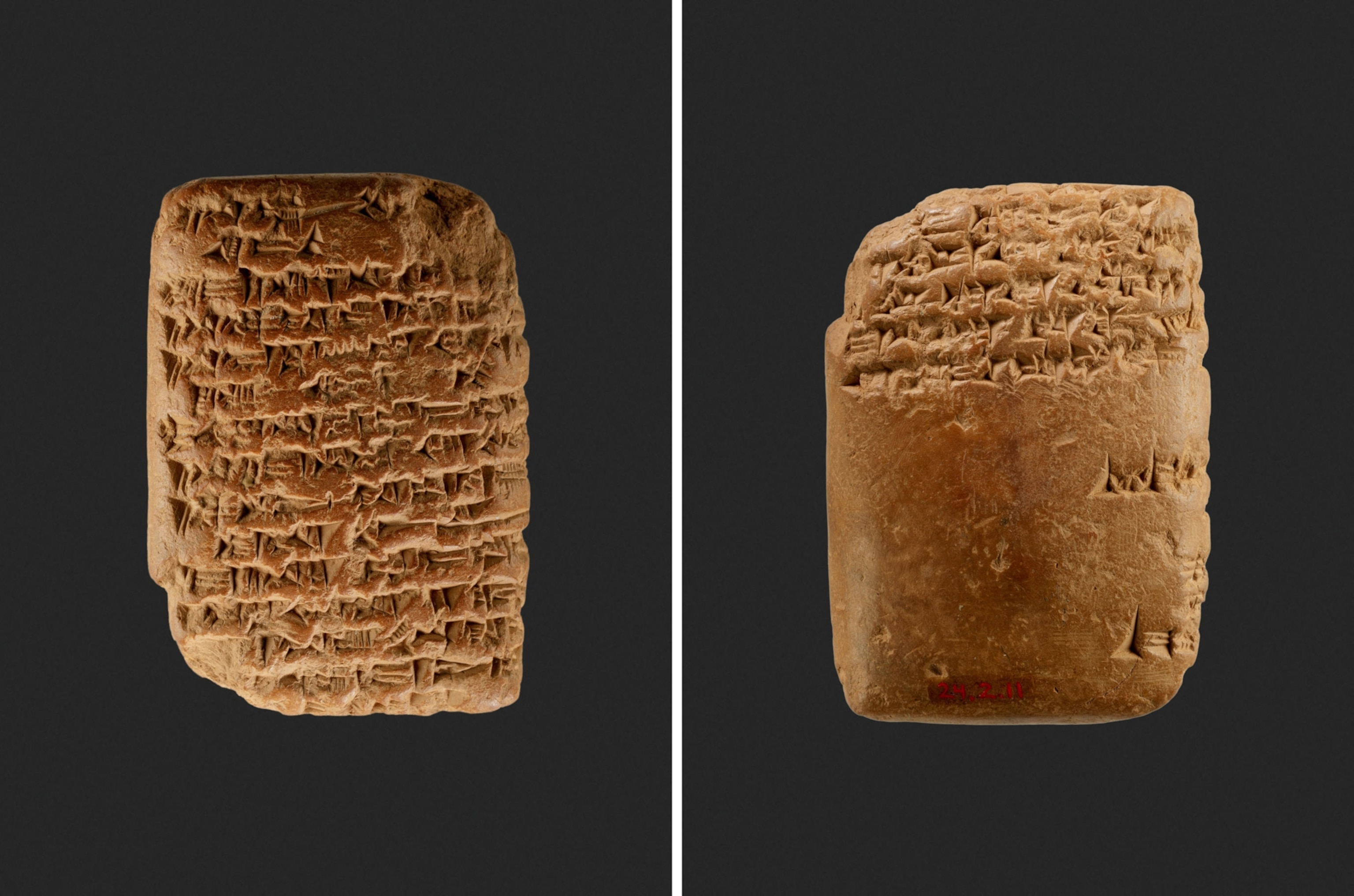 A view of the front and back of a clay tablet with covered with cuneiform script on a dark background.
