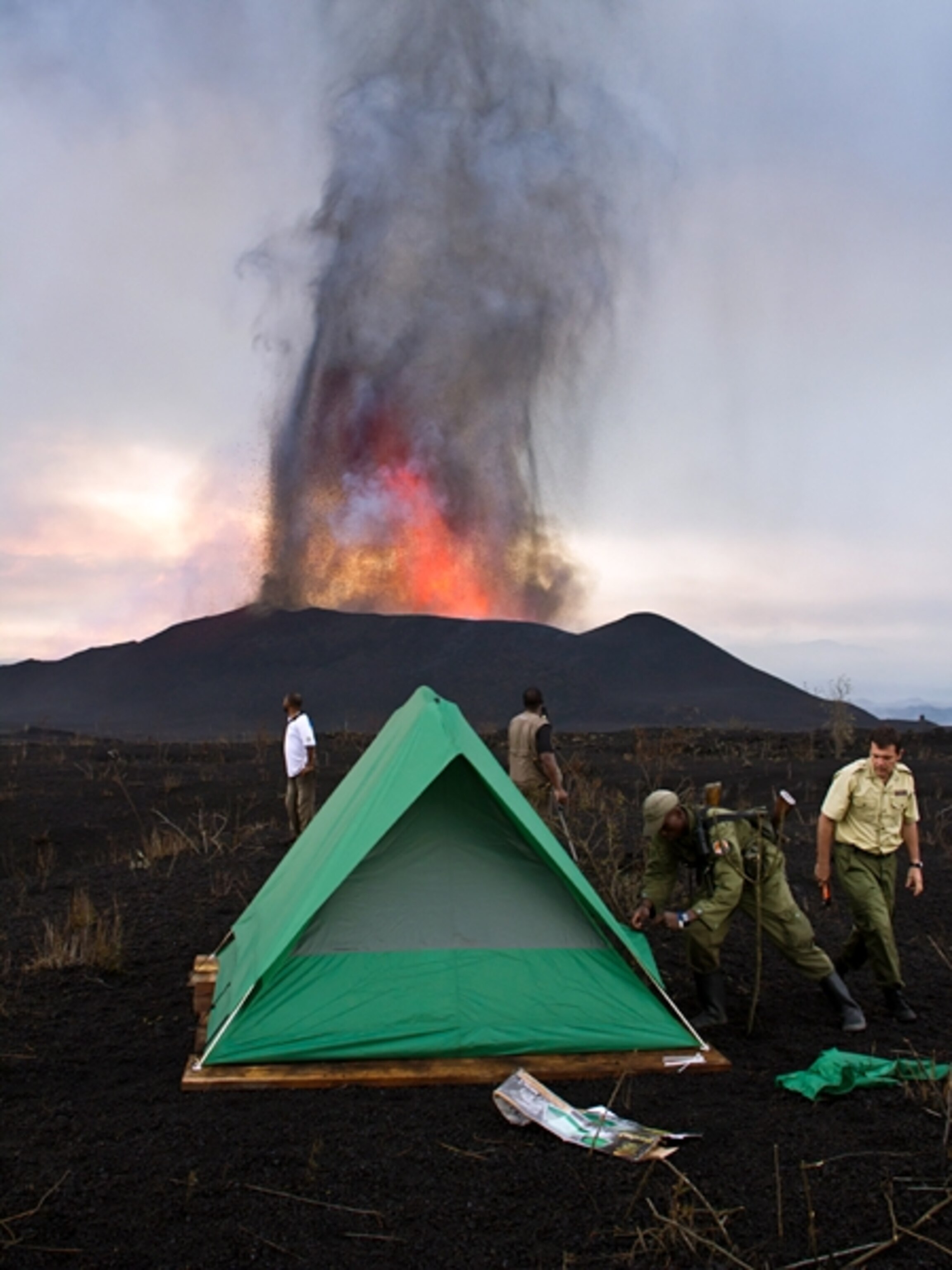 Volcano campsite picture: Virunga National Park staff and volcano experts set up a camp for an overnight tourist trek to the erupting Nyamulagira volcano, for a gallery on camping at the Virunga volcano eruption