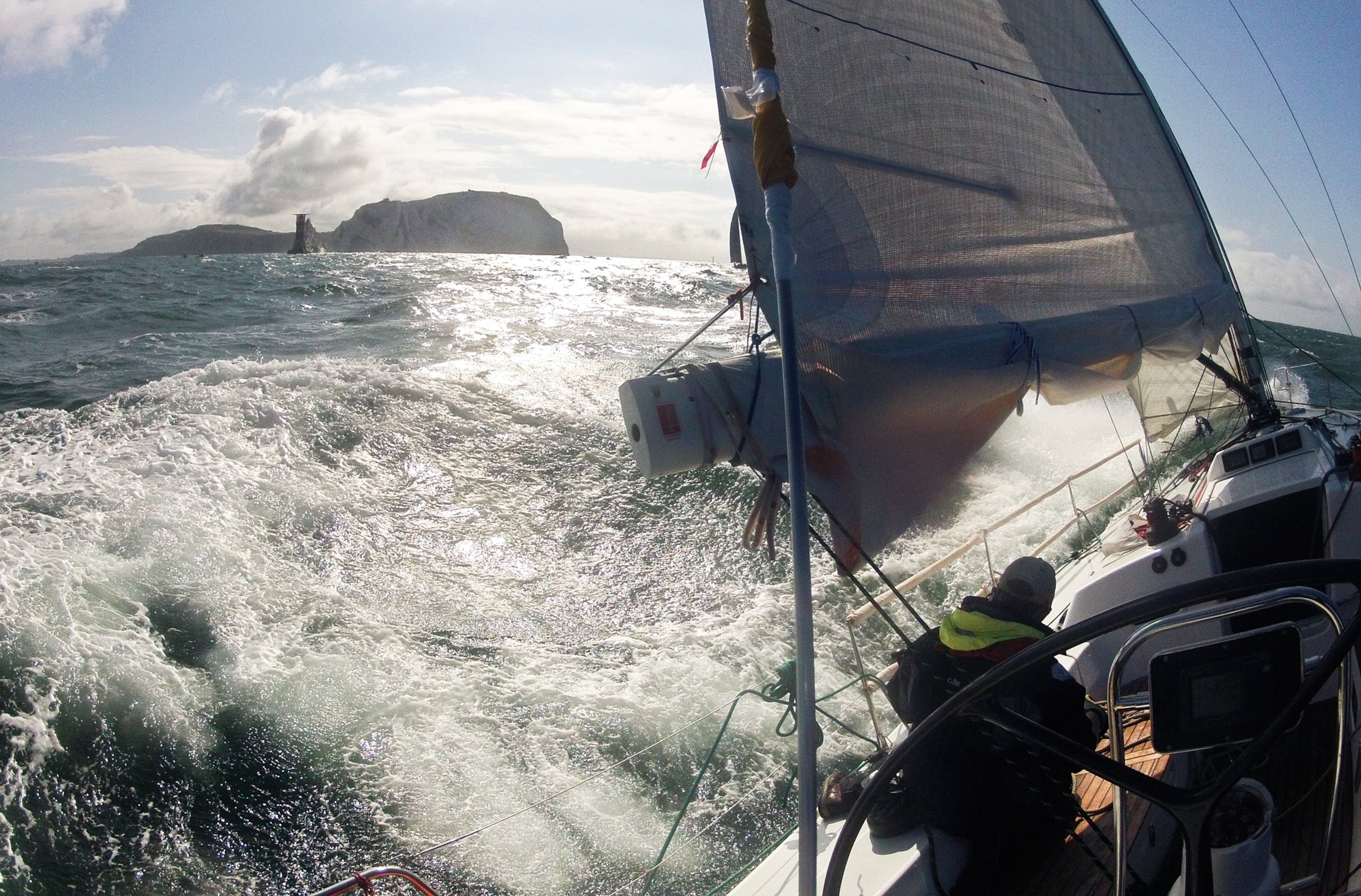 A yacht races through waves around the Isle of Wight, England.