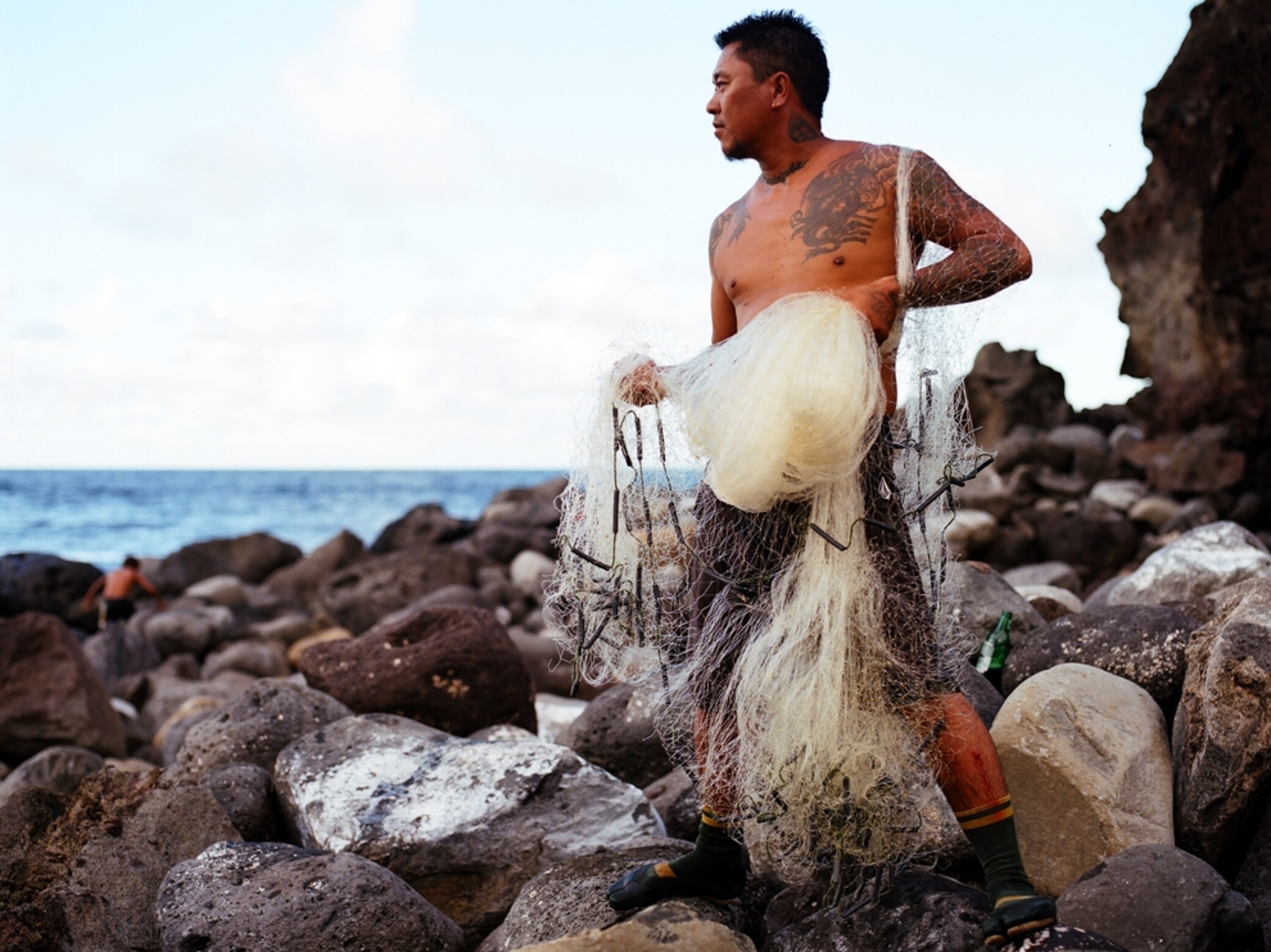 Tattoo-ed fisherman, shore of Maui, Hawaii