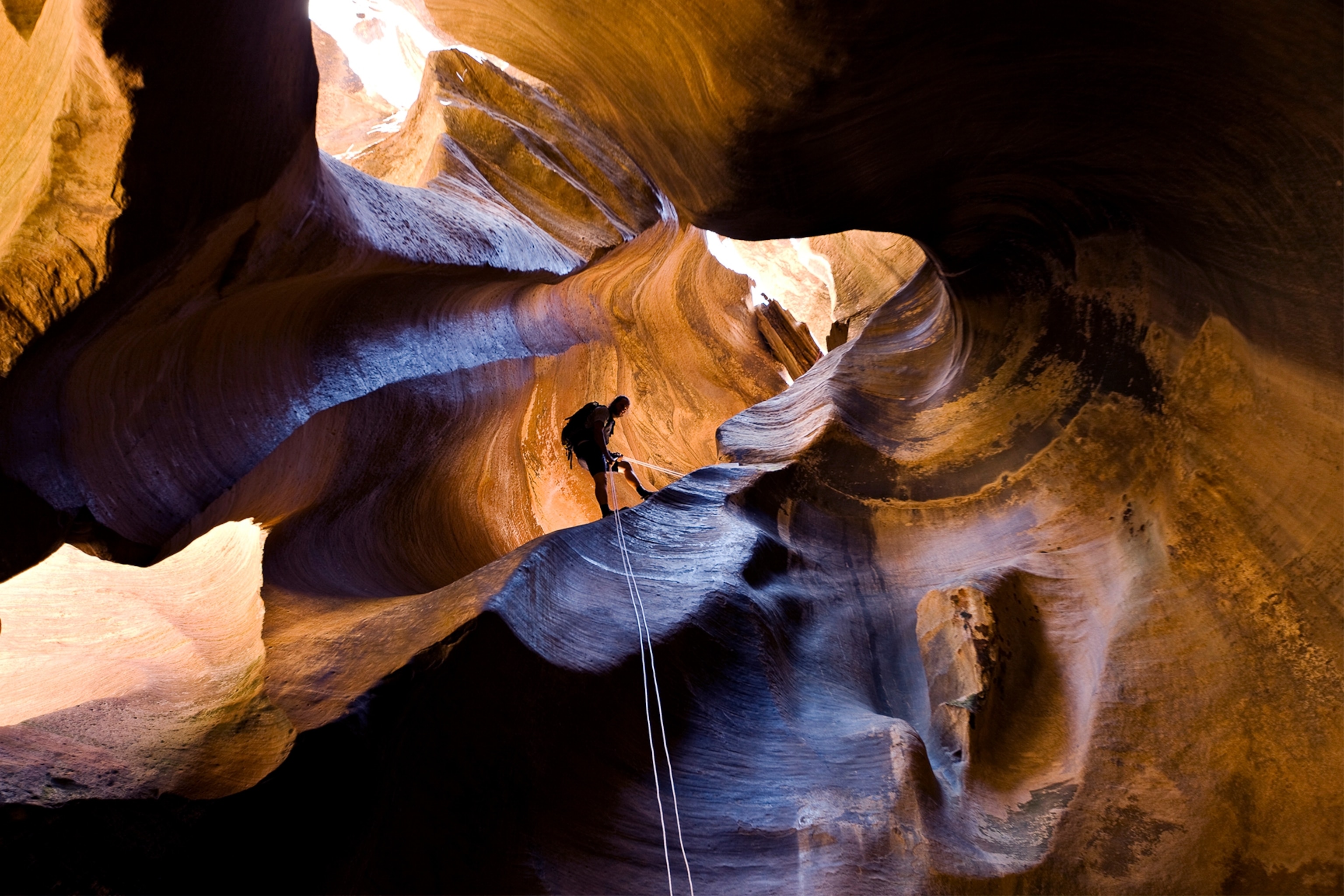 a climber rappelling in Pine Creek Canyon, Zion National Park, Utah