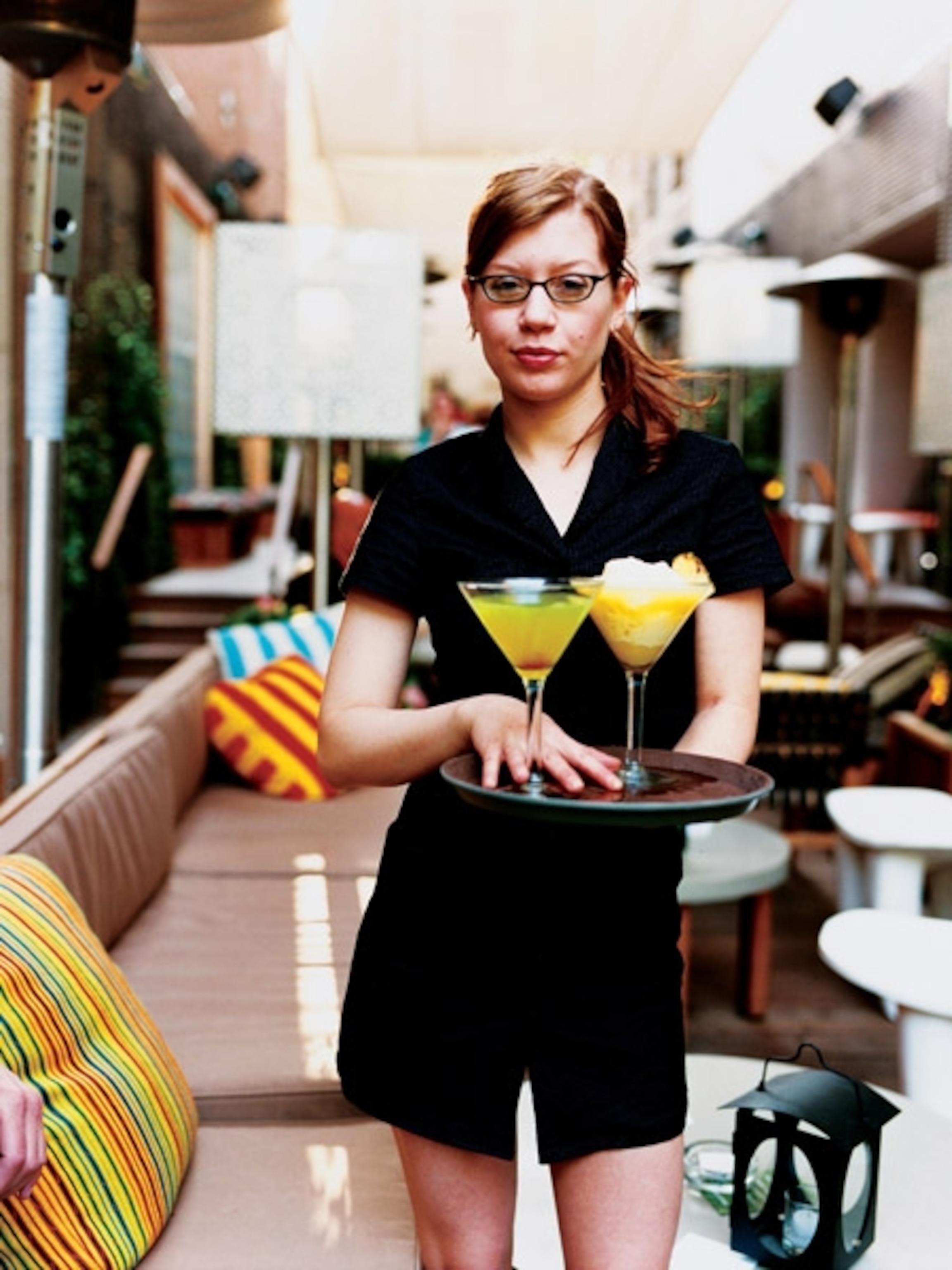 Waitress serves cocktails