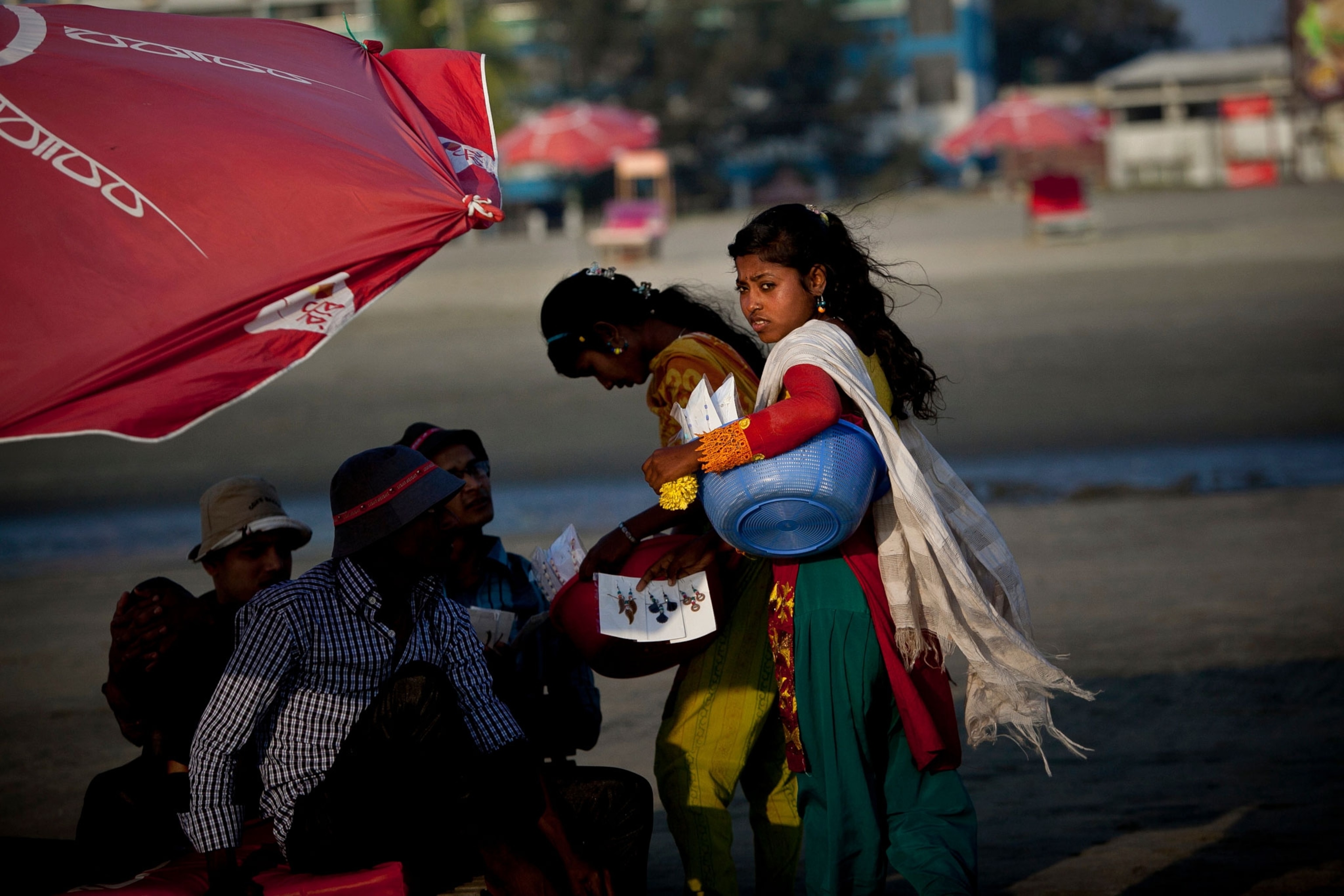 Mayasha, 12, and Nargis, 13, sell jewelry on the beach in Cox's Bazar, Bangladesh.