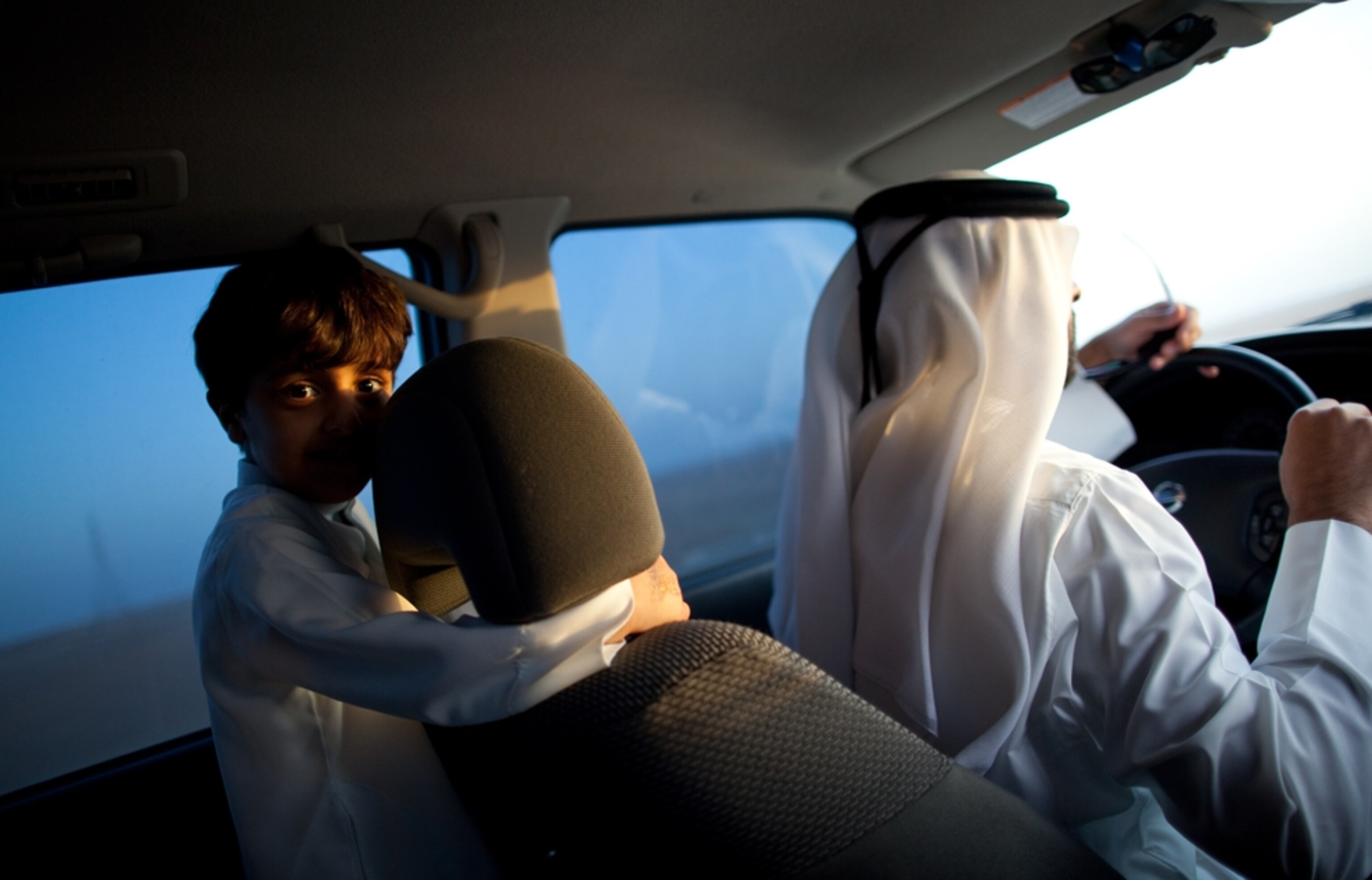 Boy riding in car in Abu Dhabi