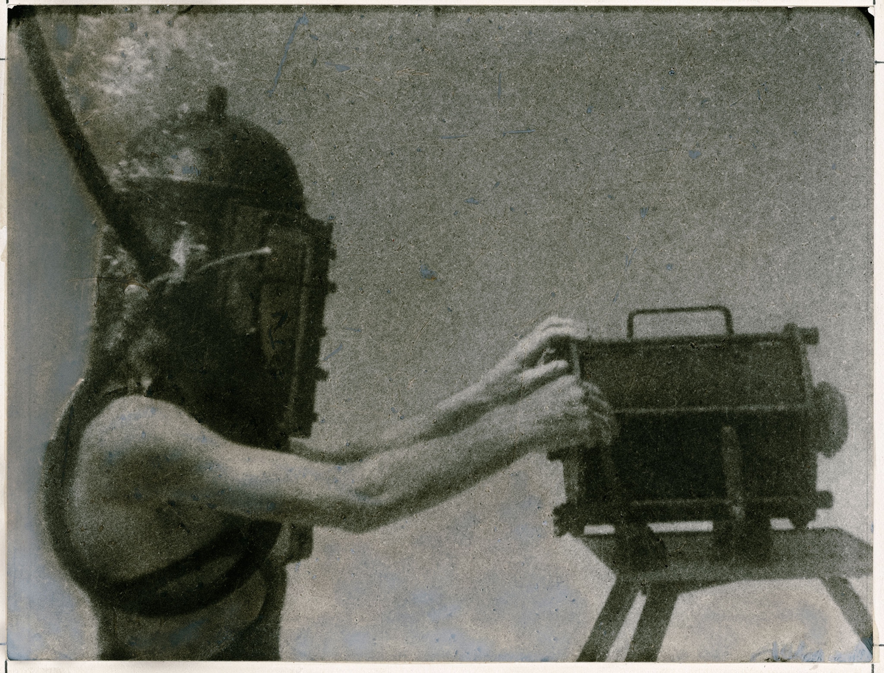 a man in a helmet photographing underwater.