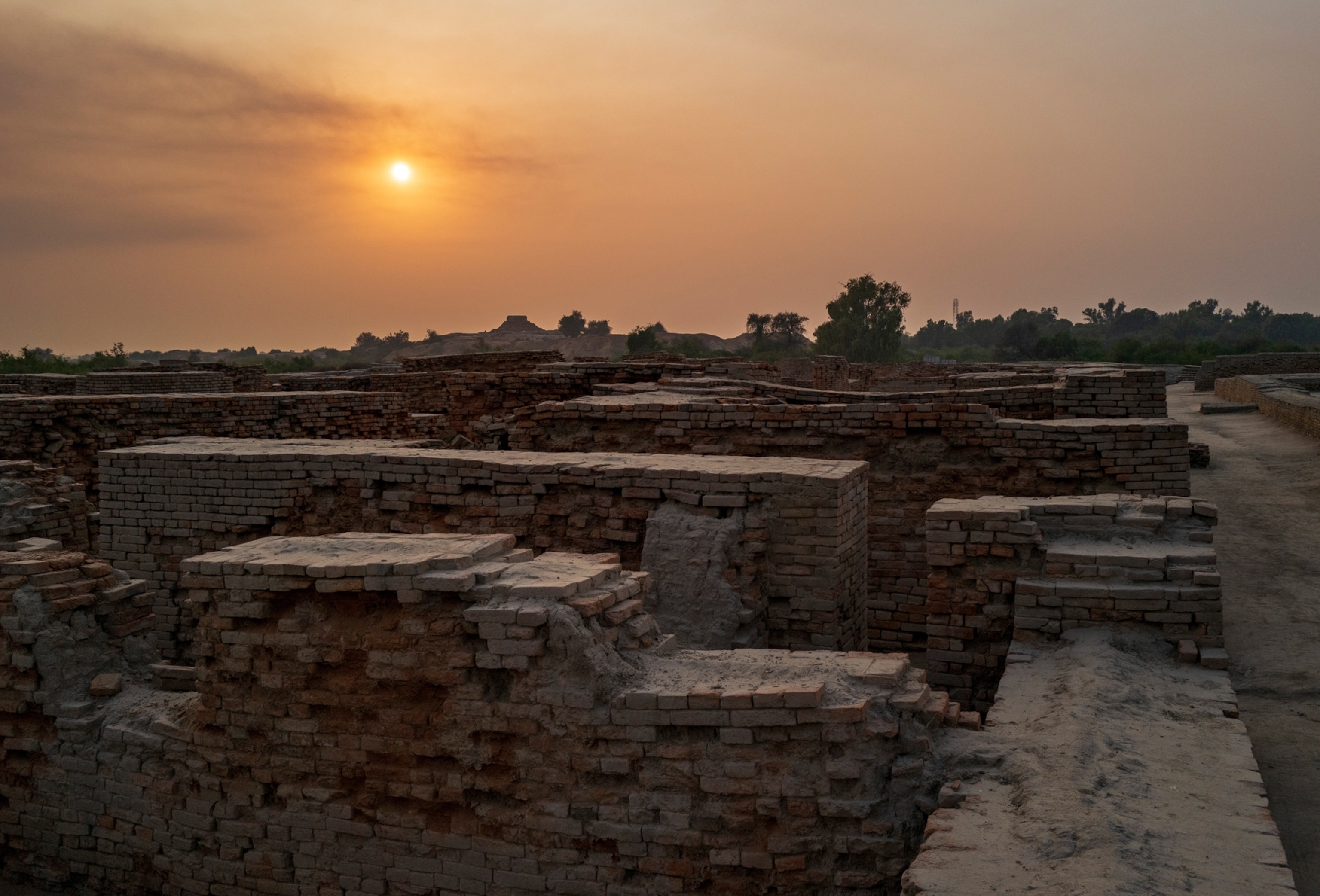 Bricks are seen beneath a setting sun